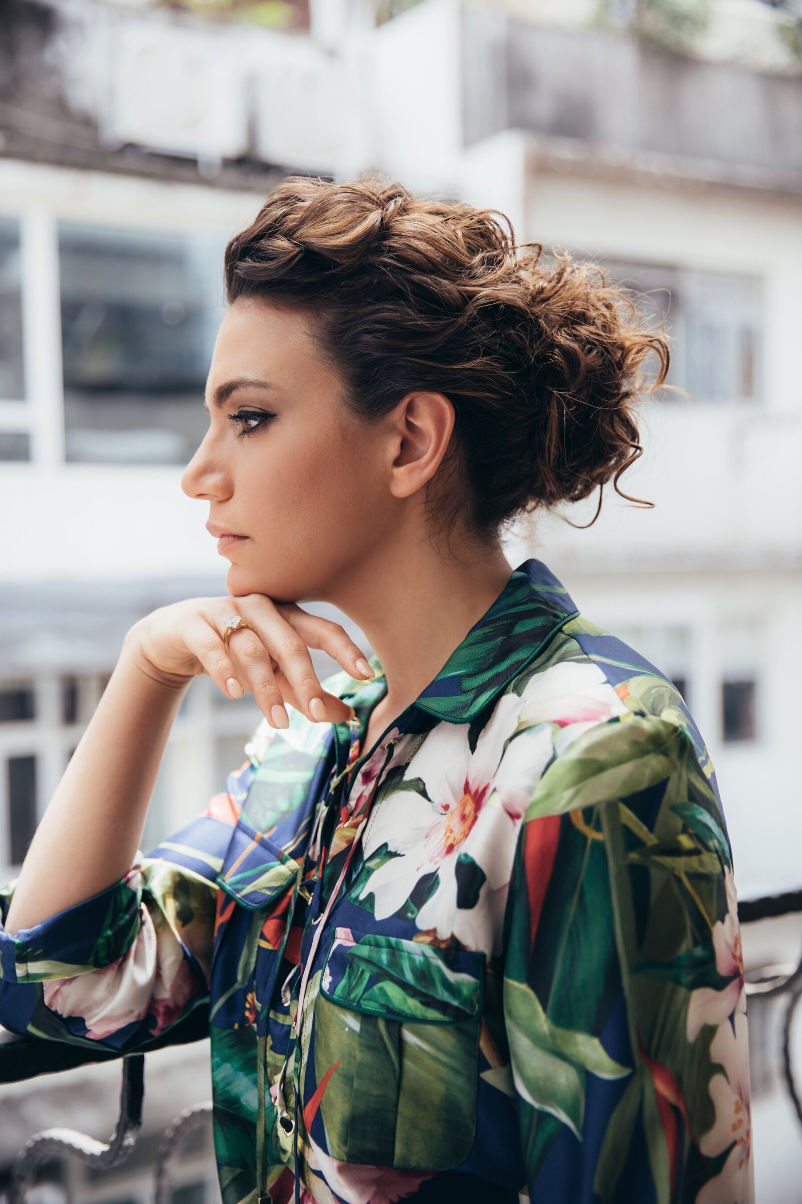 Beautiful curly hair in updo and tropical print pajamas