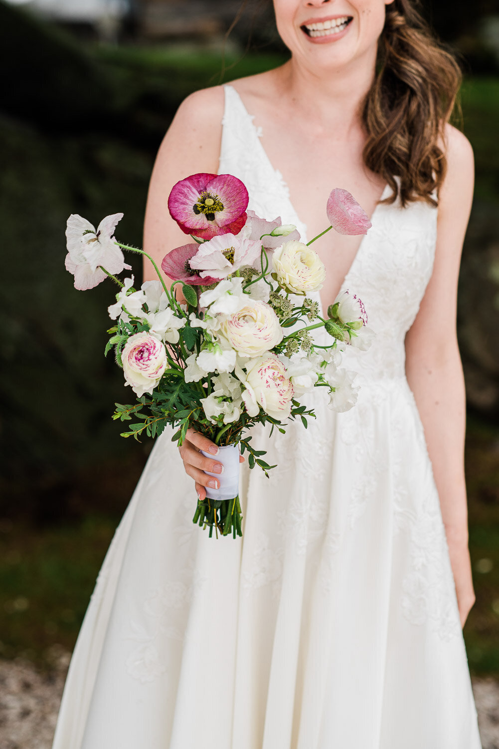 bride holding pink and white bouquet