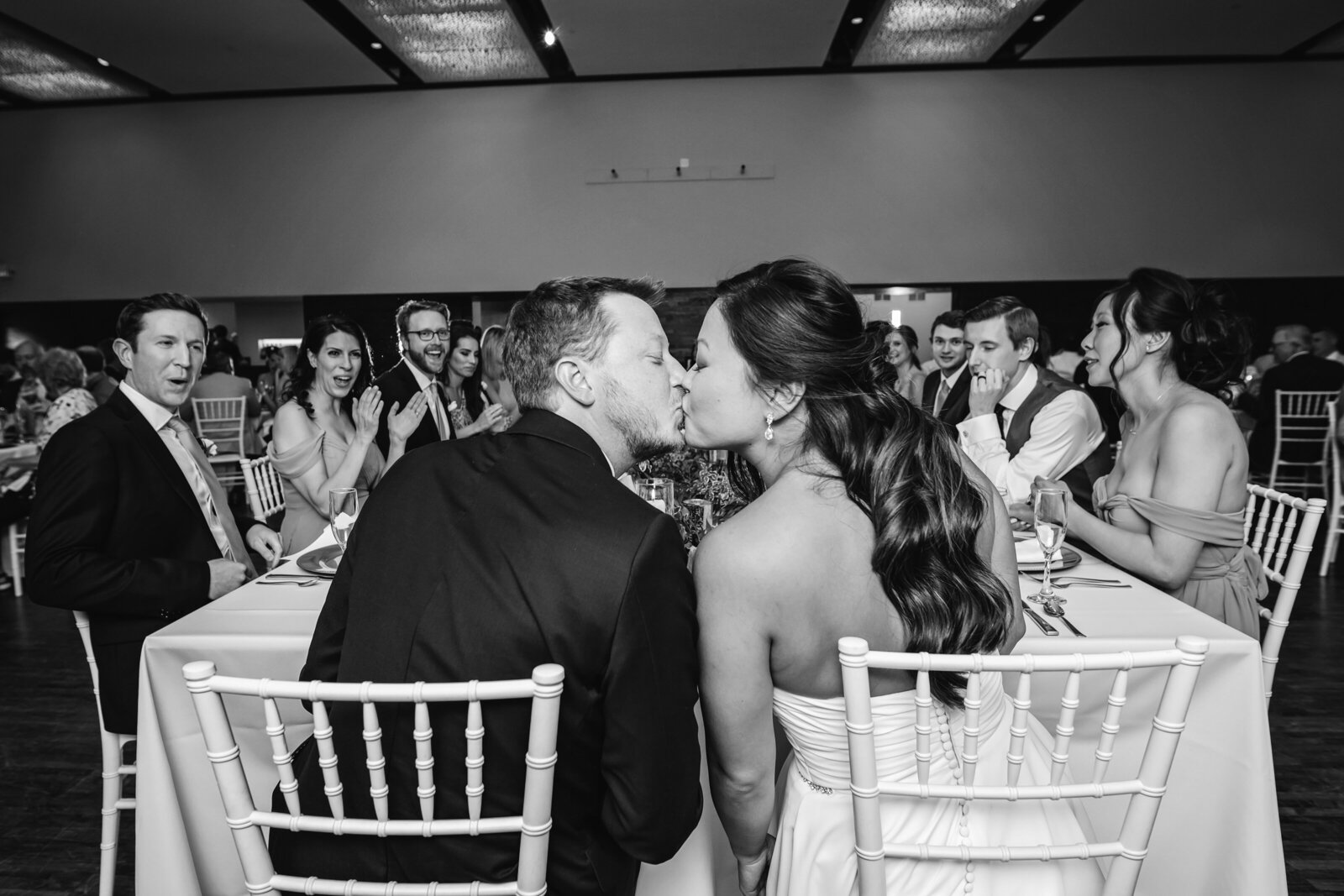 bride-groom-kiss-dinner-reception