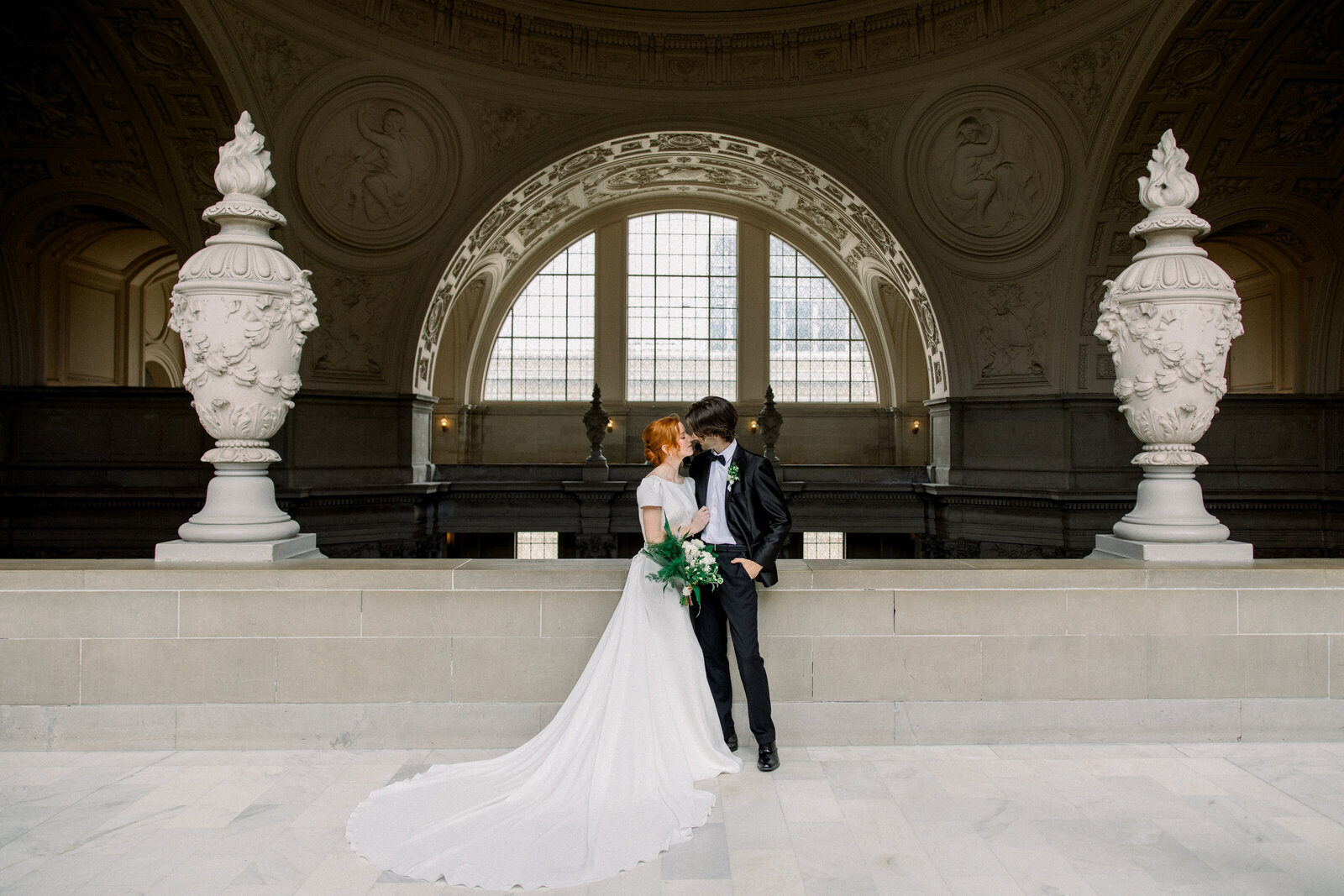 Tiffany Longeway's photography highlights the grandeur of San Francisco City Hall, providing an elegant and historic setting for this timeless wedding portrait.