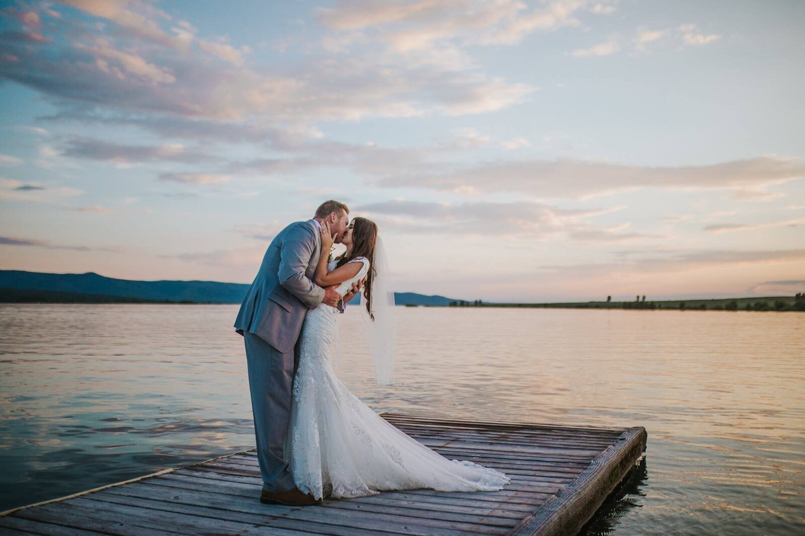 Sacramento Wedding Photographer captures beach wedding with bride and groom kissing on dock