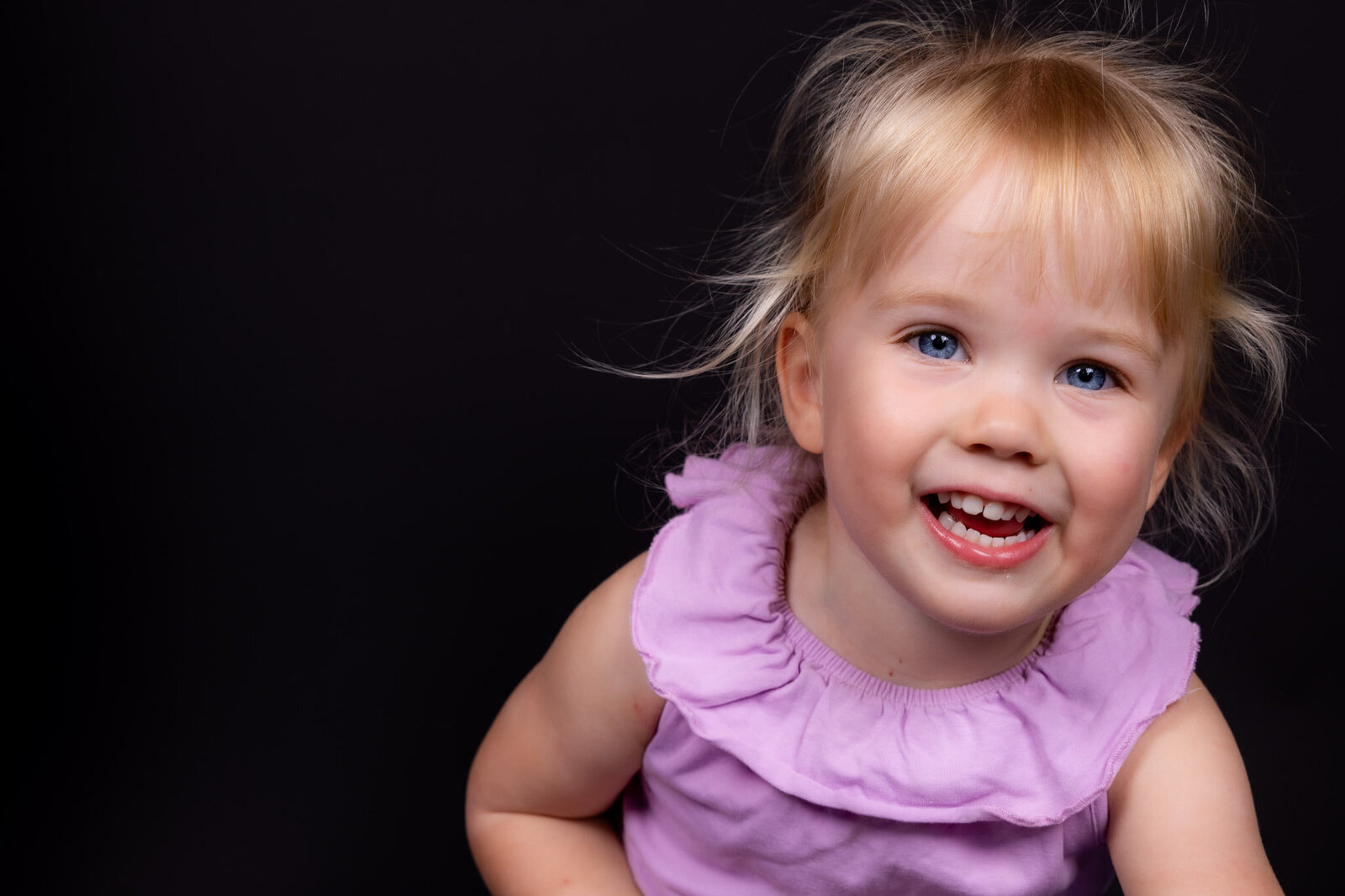 kinderfoto-portretfoto-Hellevoetsluis-zwarte-achtergrond-fotograaf-professionele-fotoshoot-lachend-kind-073