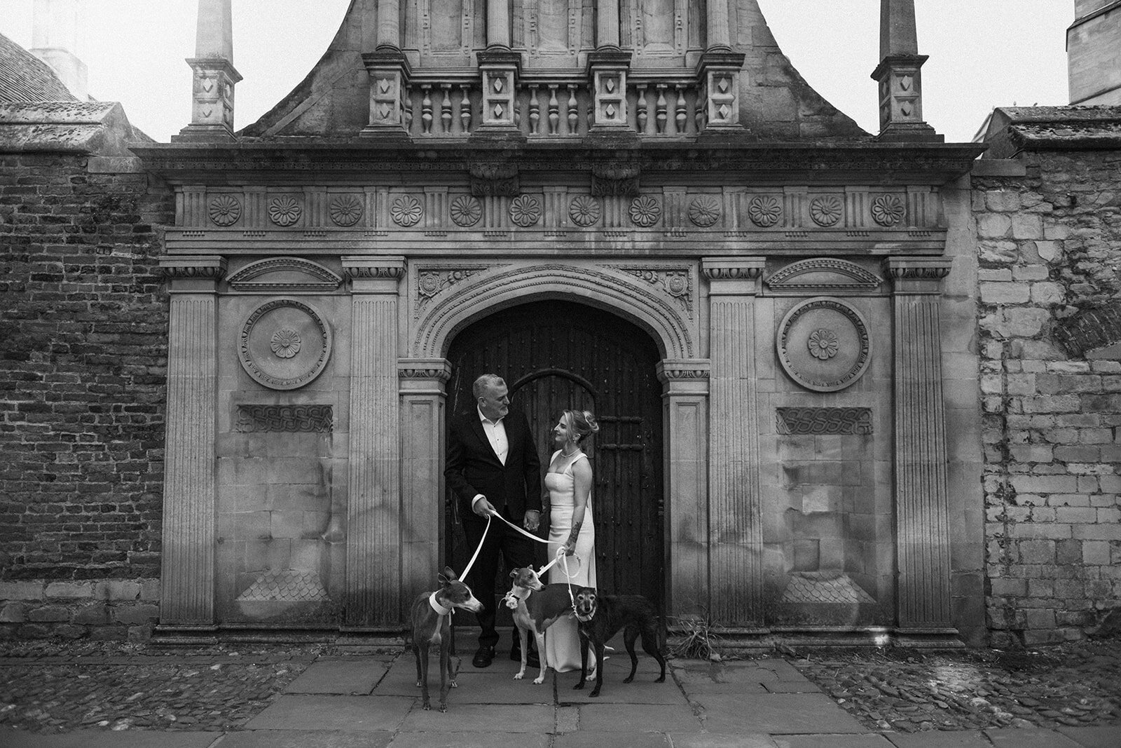 Luxury wedding couple with their 3 dogs outside their Kent wedding venue