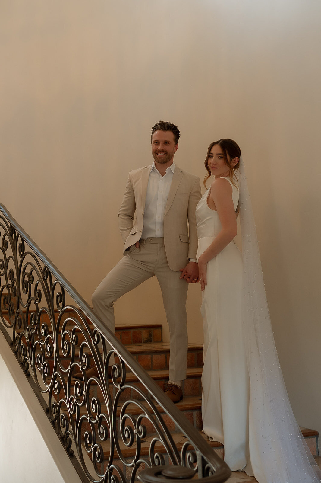 bride and groom walking up stairs during elopement