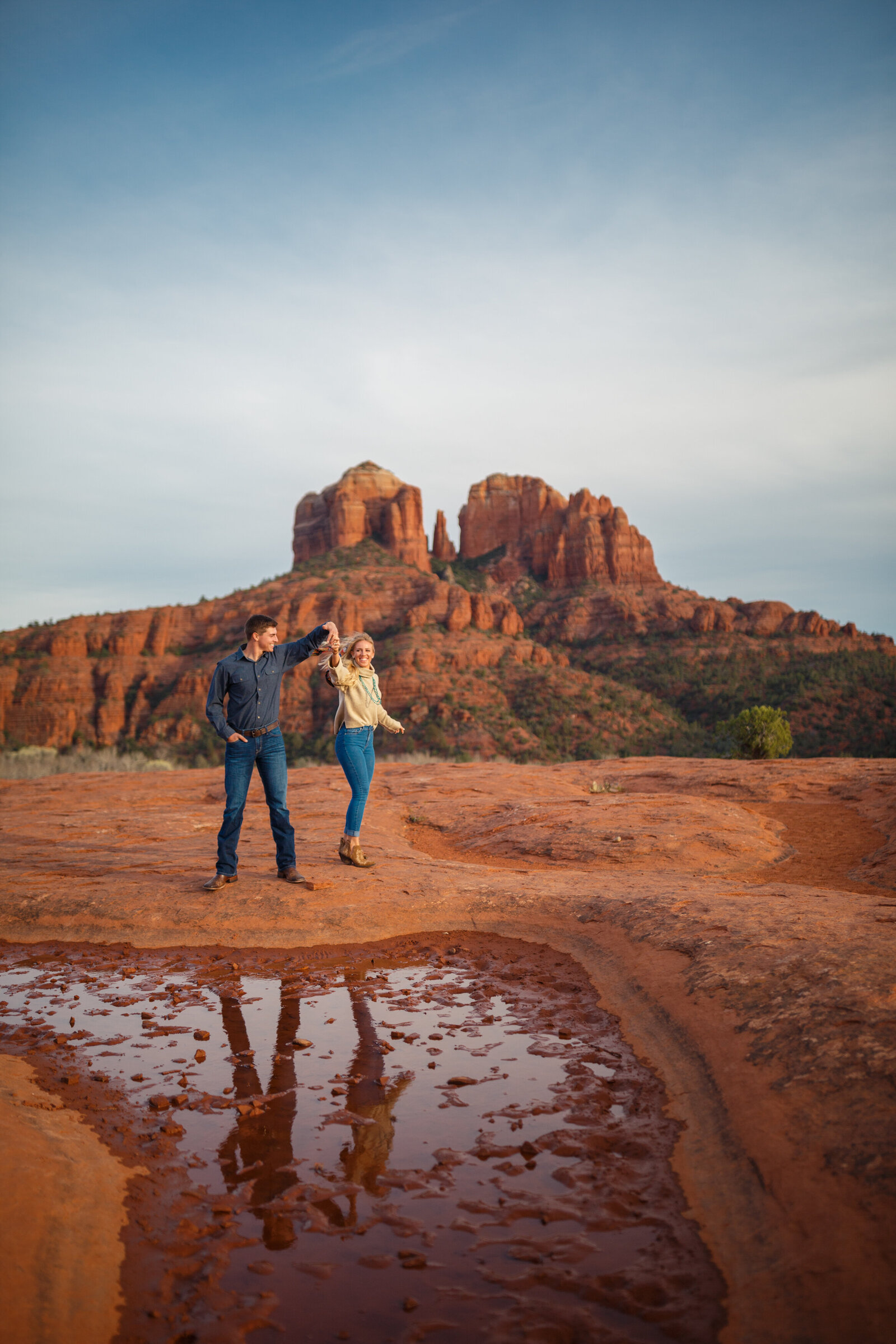 western couple two stepping during engagement photos in sedona