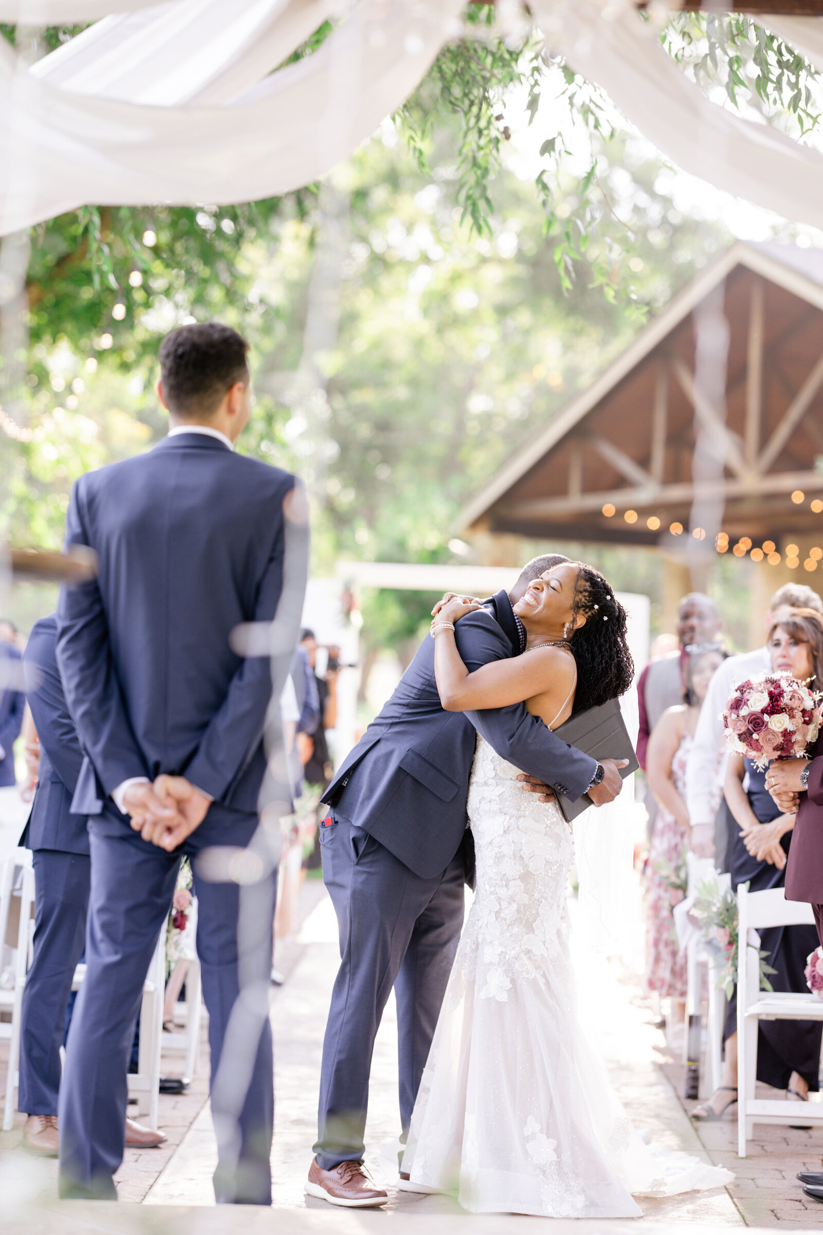 Bride hugging father at the alter before ceremony