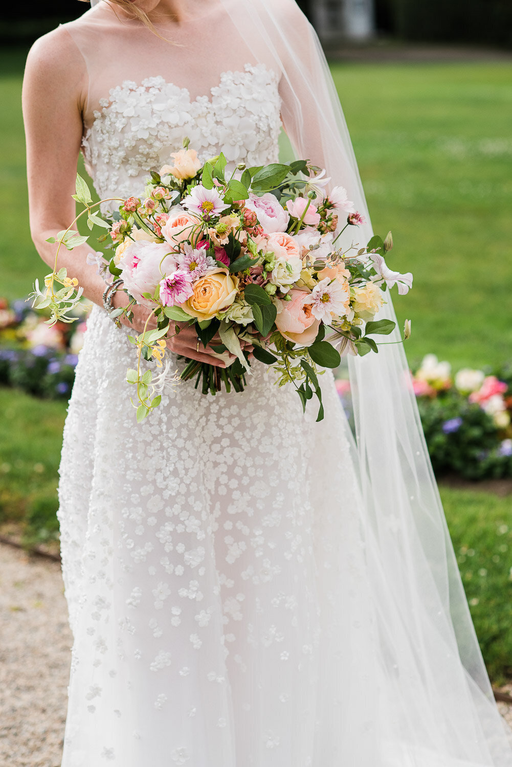bride holding bouquet with soft pastels