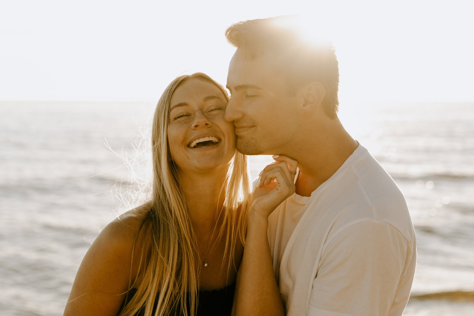 Couple laughing during a sunset on Lake Michigan