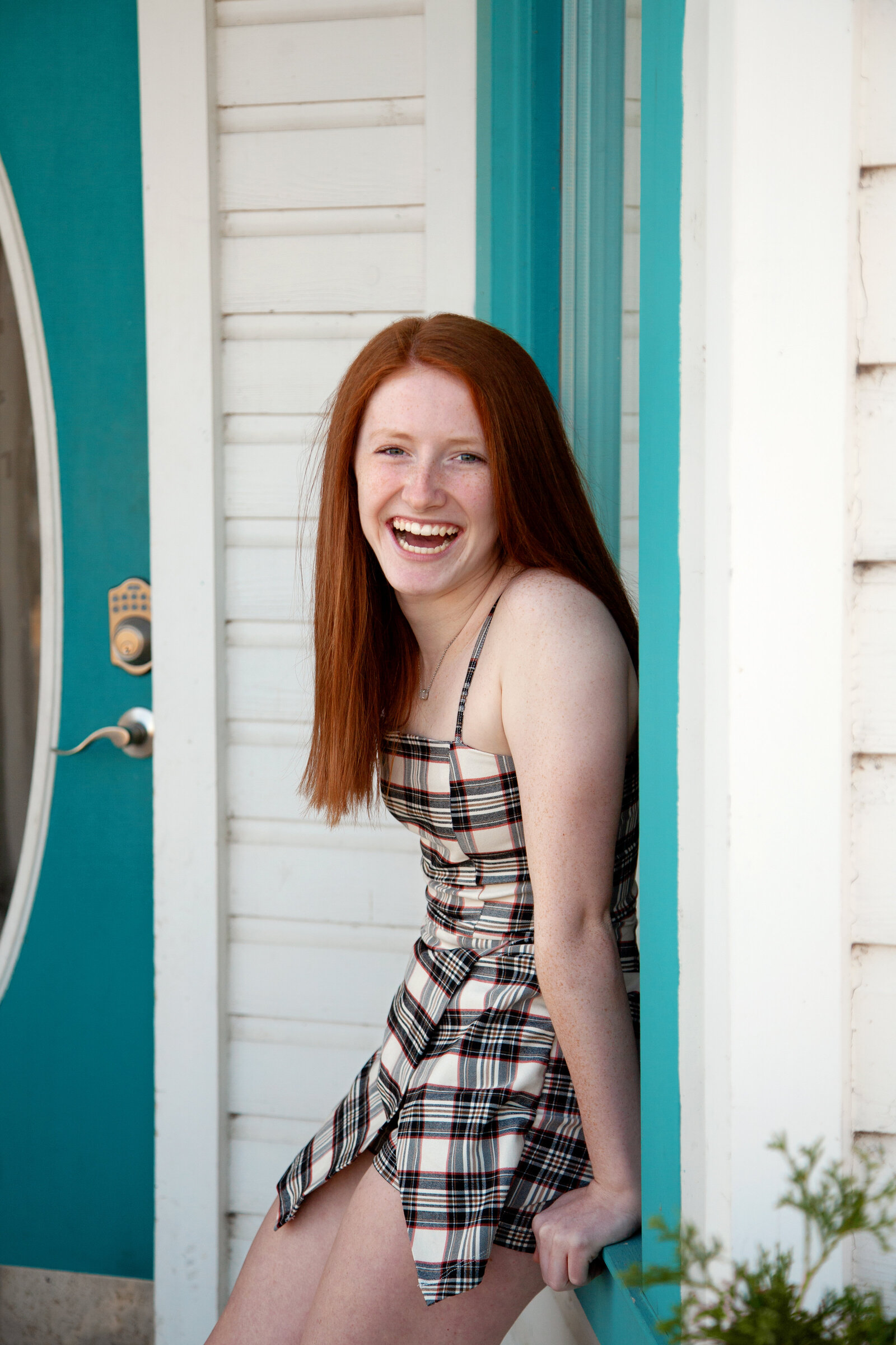 Senior girl with red hair, laughing.