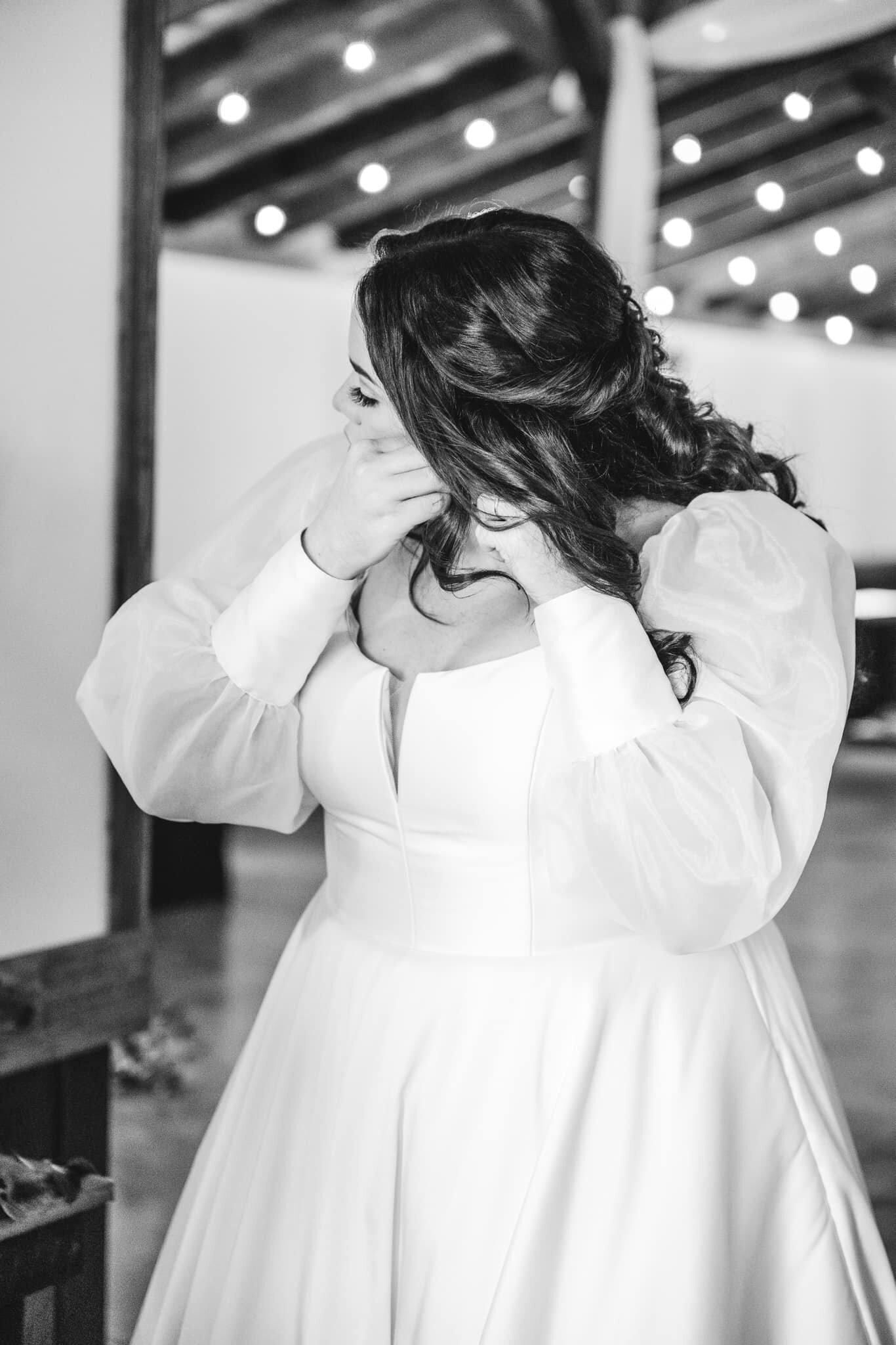 bride with lights of barn bandw