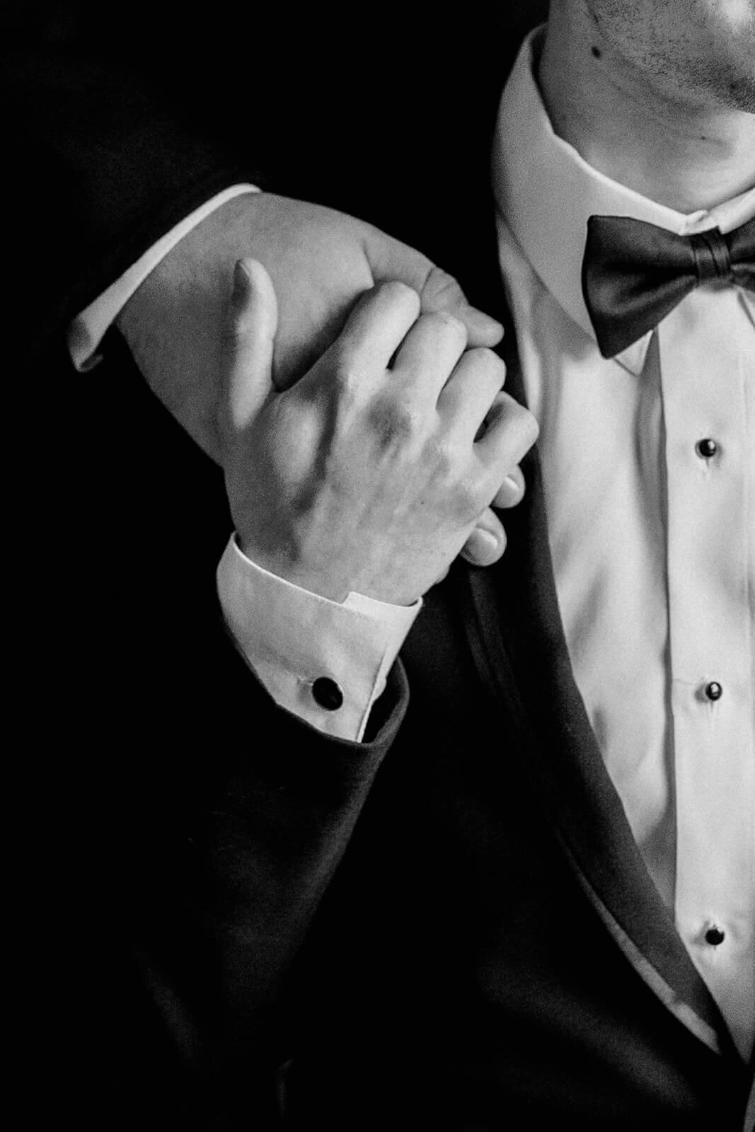 two grooms holding hands wedding portrait