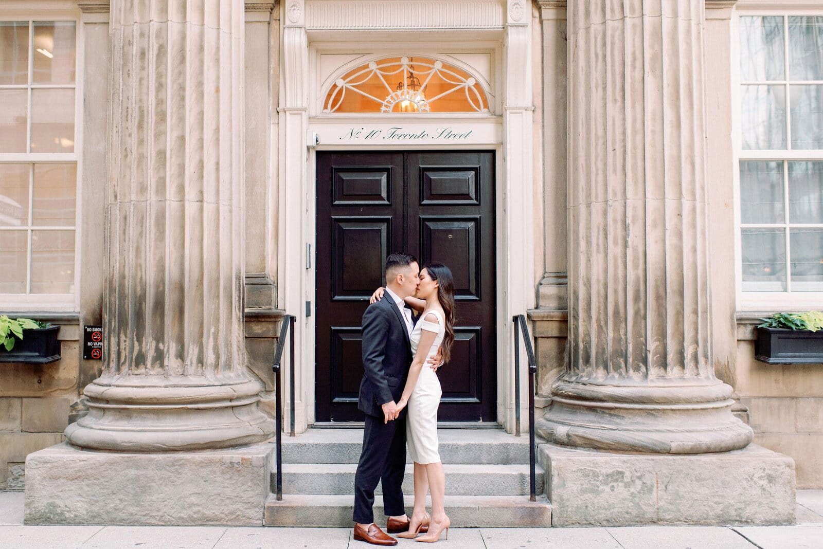 Modern Editorial Couple Embrace in front of Toronto Post Office Engagement Downtown Financial District Romantic Jacqueline James Photography