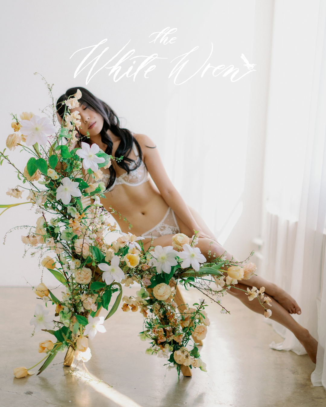 Kohnur bride in soft boudoir editorial with natural makeup, loose waves, and romantic floral styling featured on The White Wren