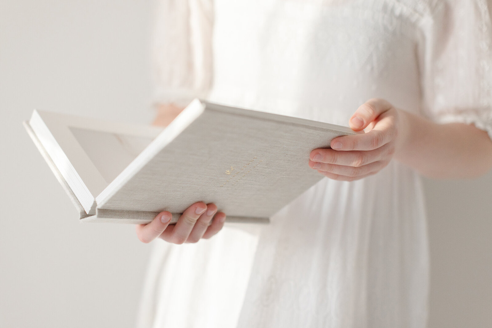Fresno Photographer holding heirloom album, investment guide, one good shot 