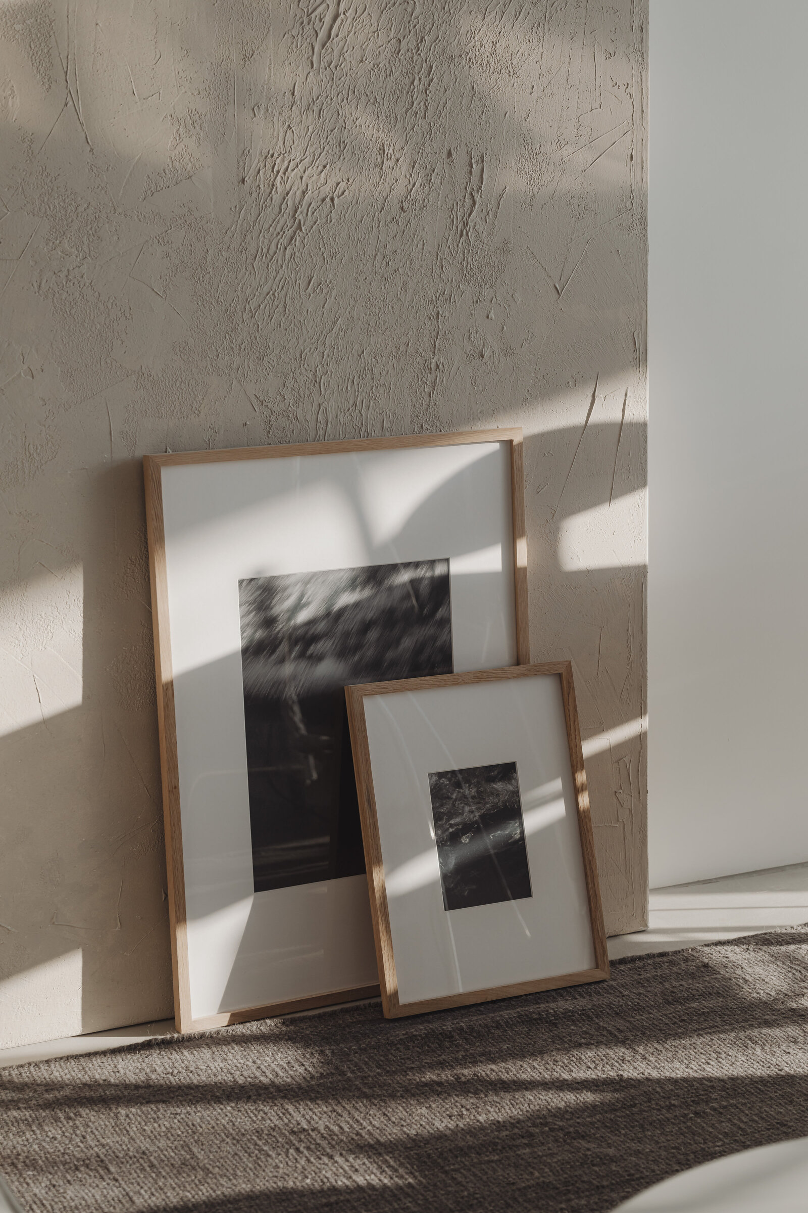 kaboompics_two-framed-pictures-leaning-against-a-textured-wall-36963