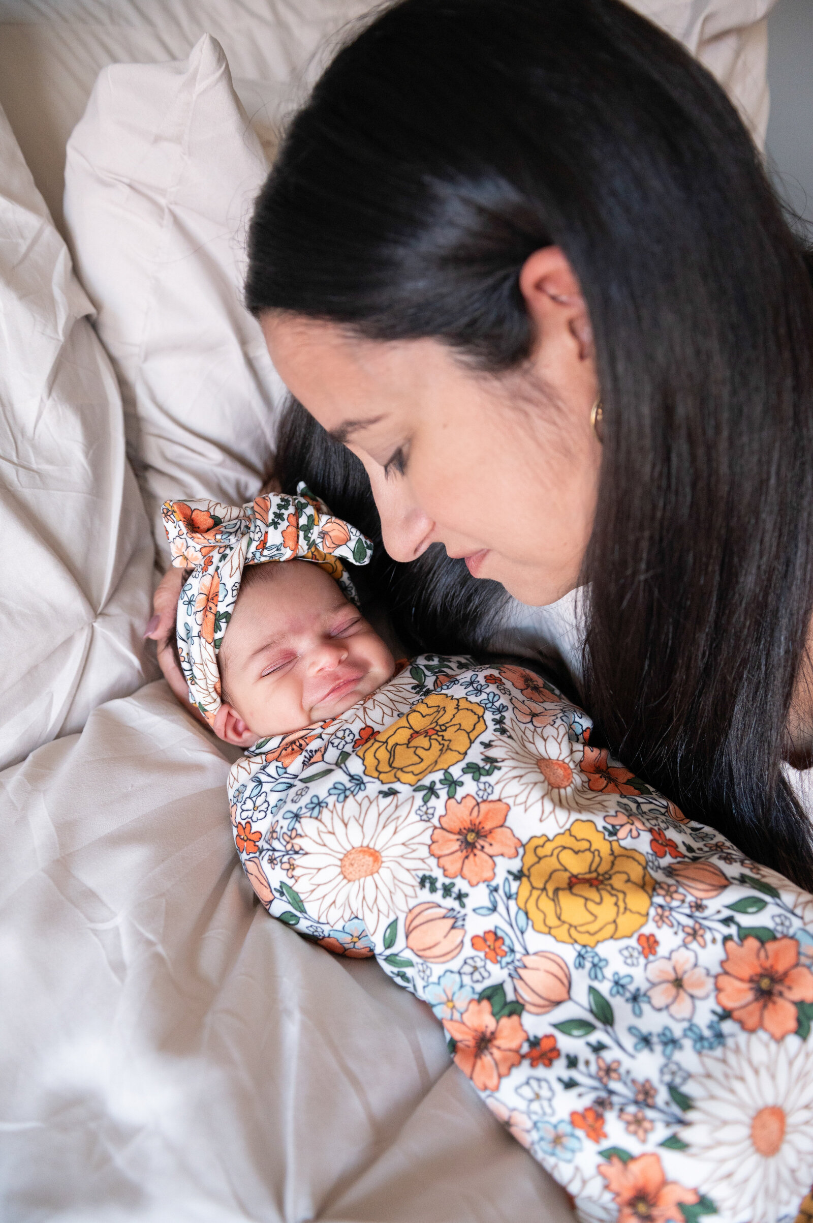 baby girl smiling in a floral swaddle