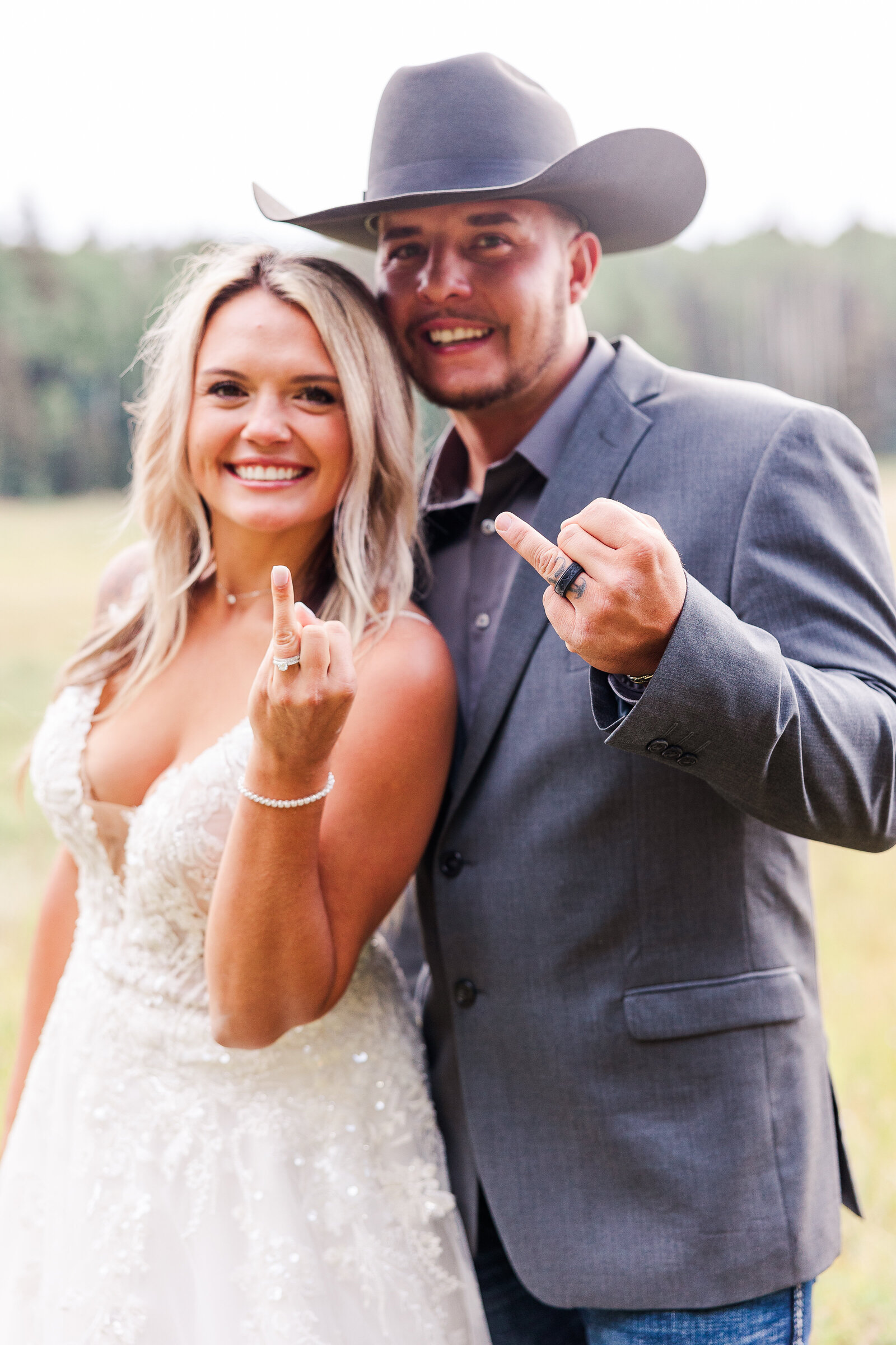 Newlywed show off their wedding rings to photographer in this capture 