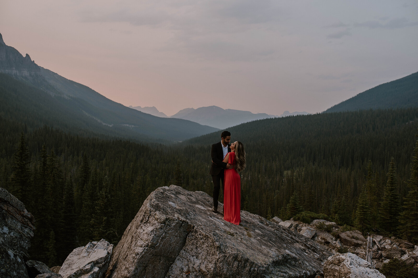 Big landscape photo of engaged couple at Moraine  Lake, Alberta