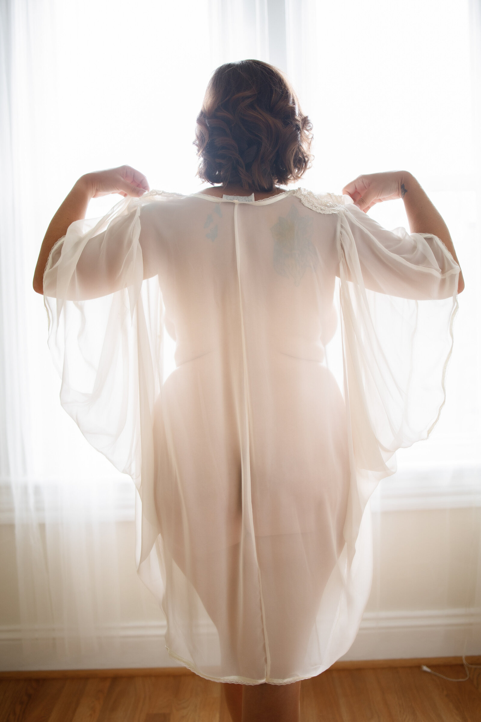 Back of woman wearing white bathrobe