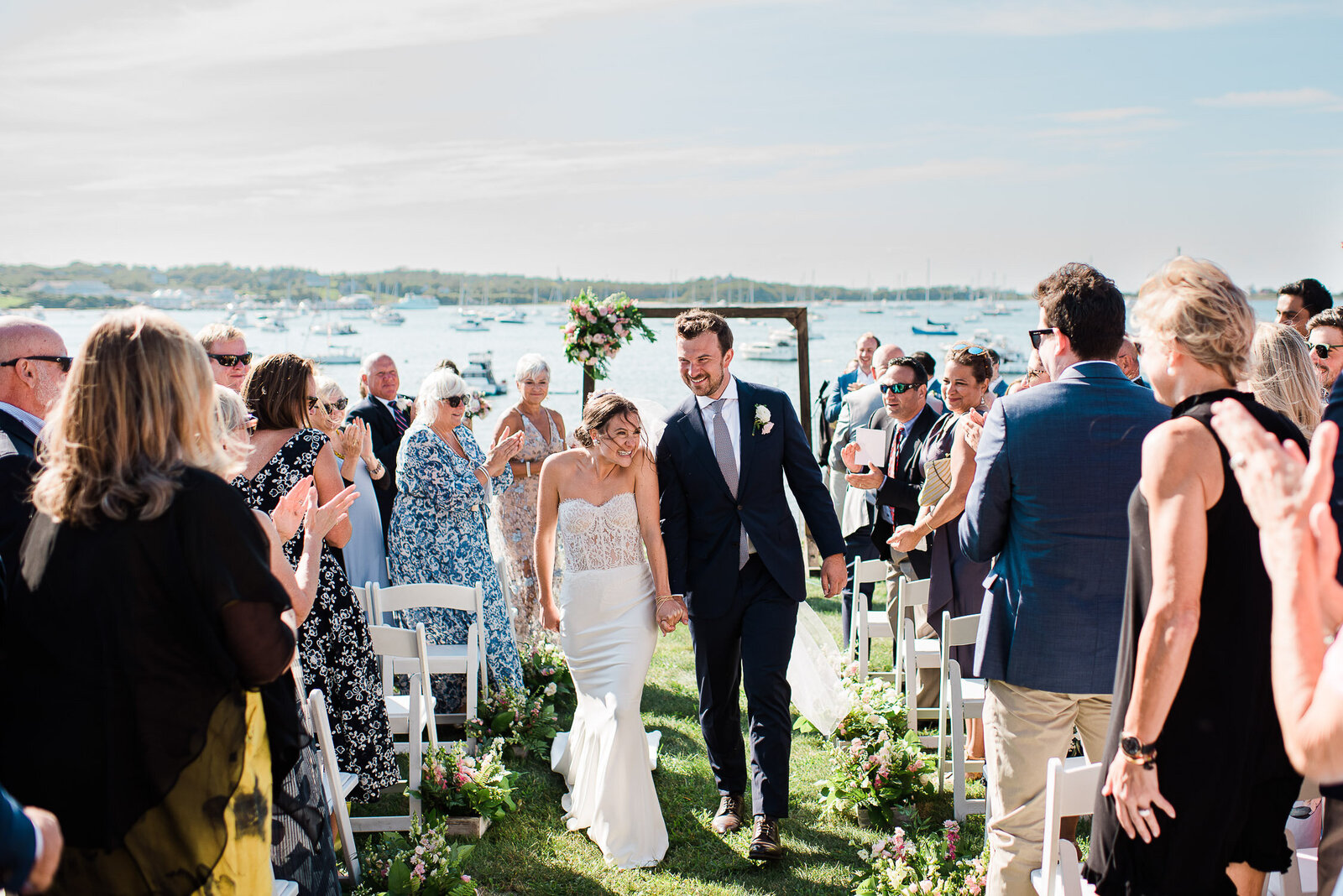 couple down aisle outside by water