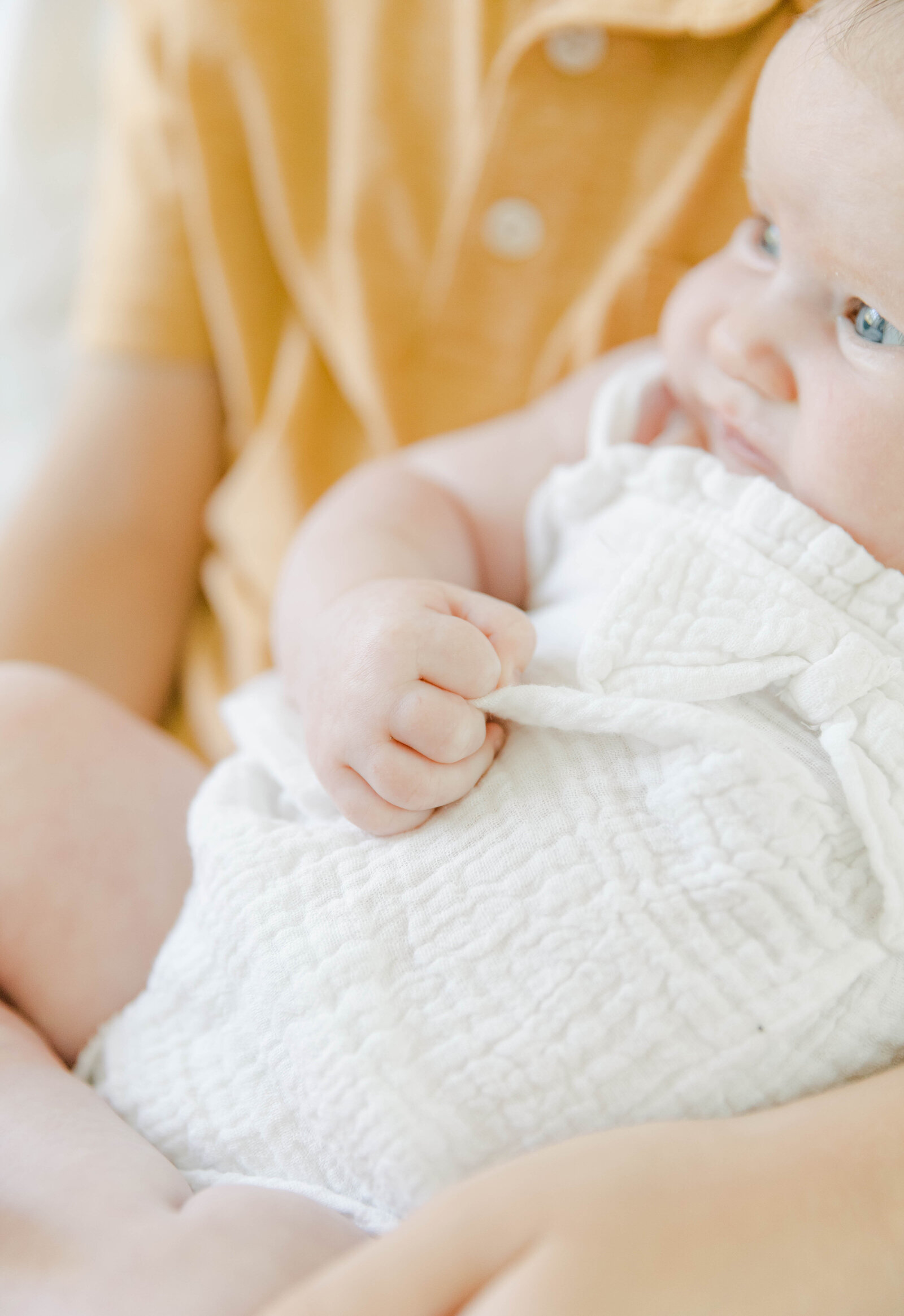 A child is holding a baby in a white shirt during a Palmetto Bluff photoshoot.