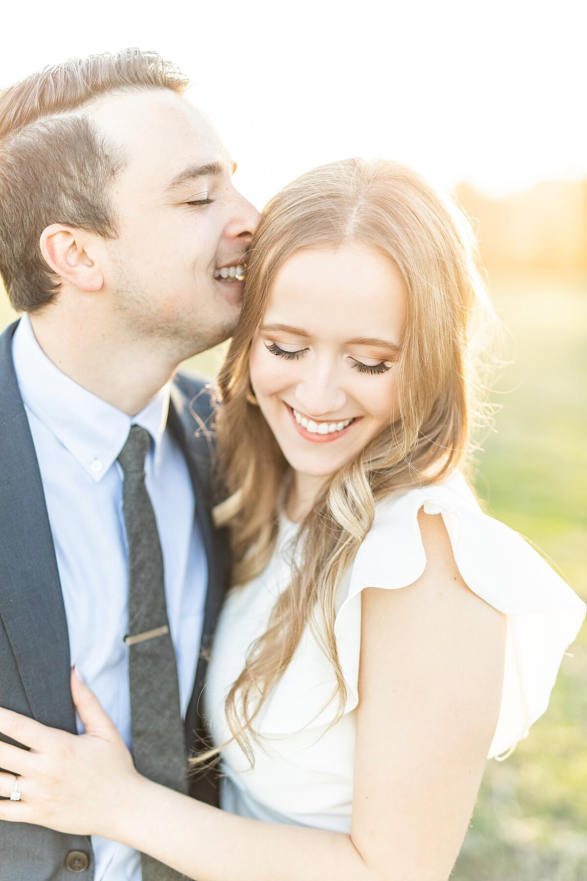 Couple laughing at sunset.