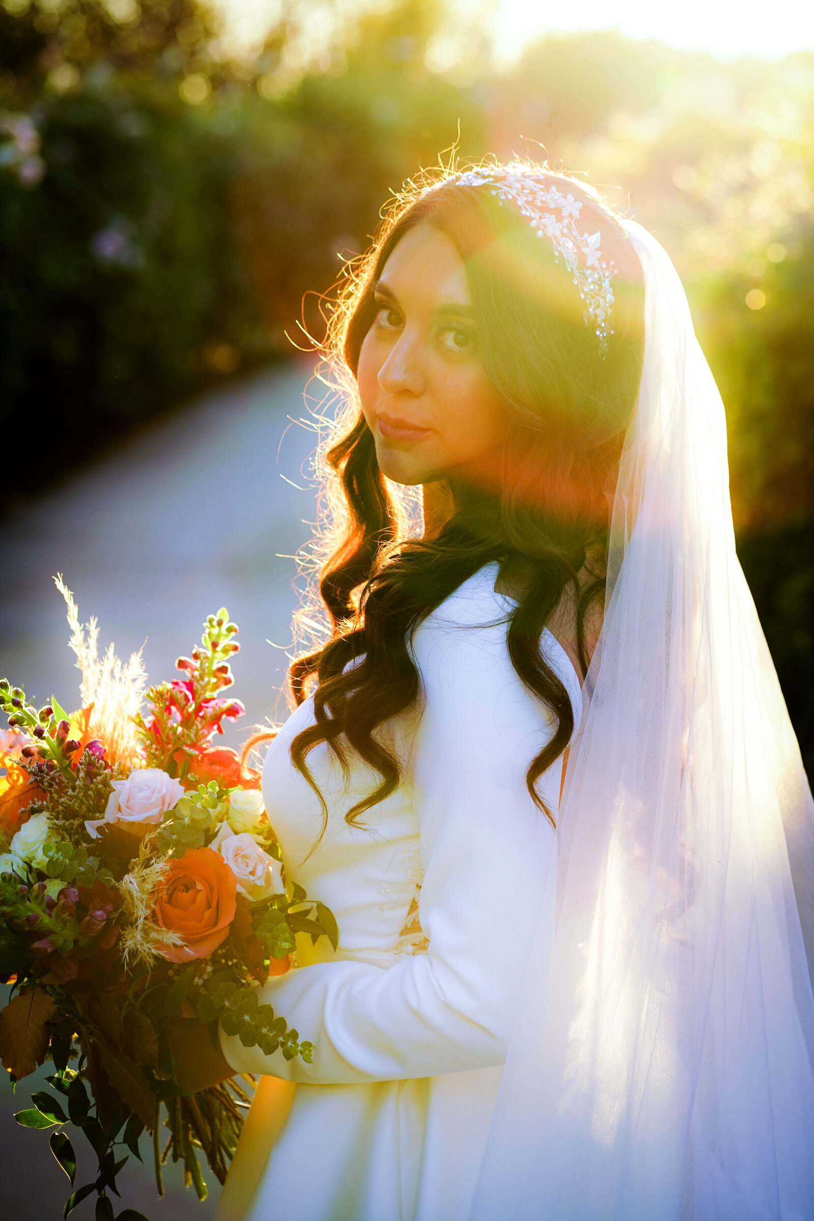 Newport Beach Wedding Photographer bride holding floral bouquet and looking over shoulder