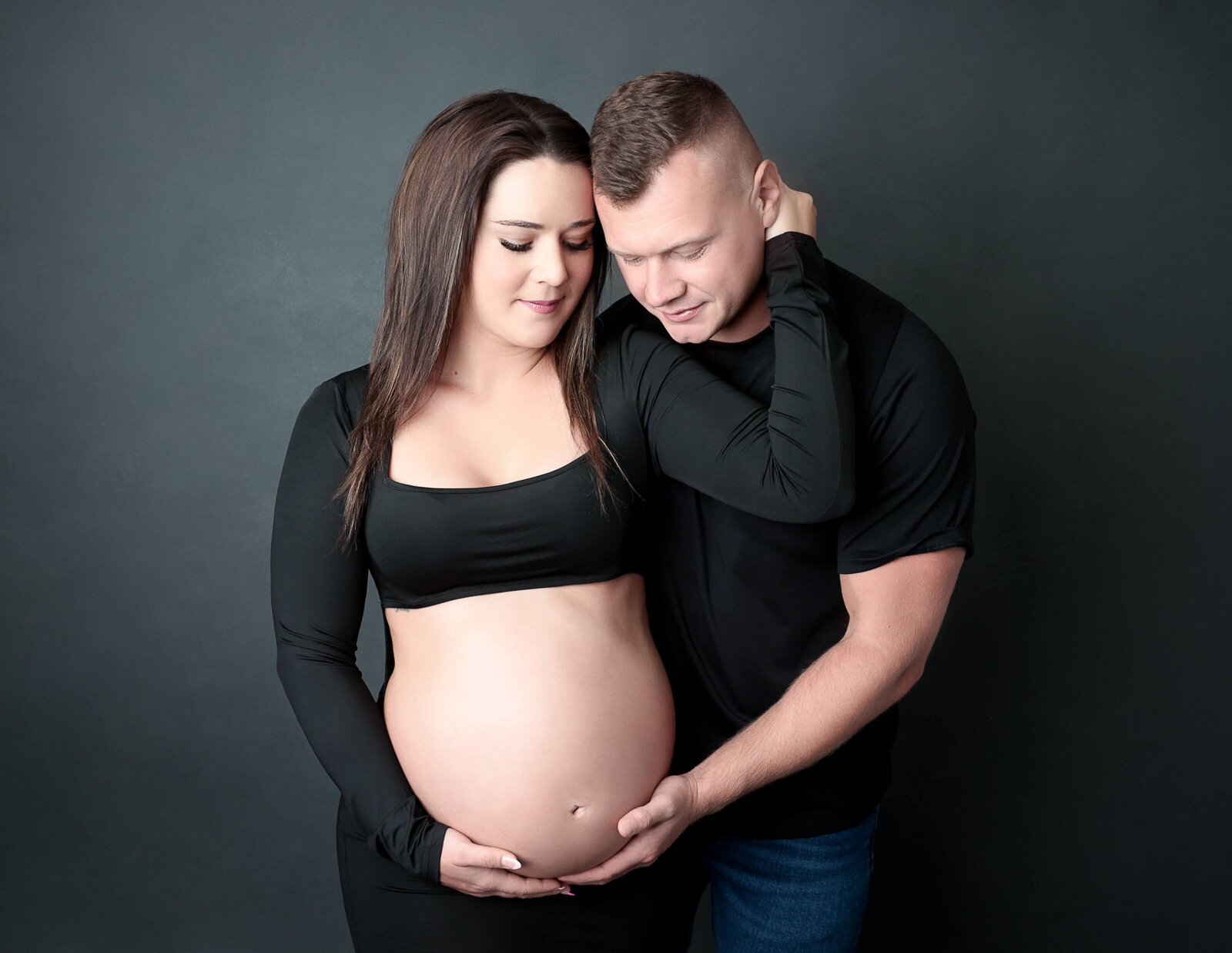 Maternity couple posed at our studio in Rochester, NY.