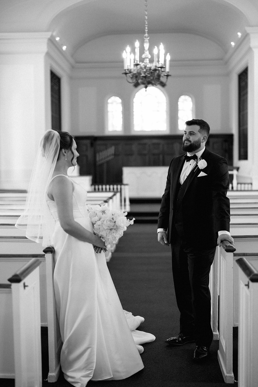 Bride and groom sharing a first look inside Mary Martha Wedding Chapel, photographed by Michigan wedding photographer Raechel Marie Photo