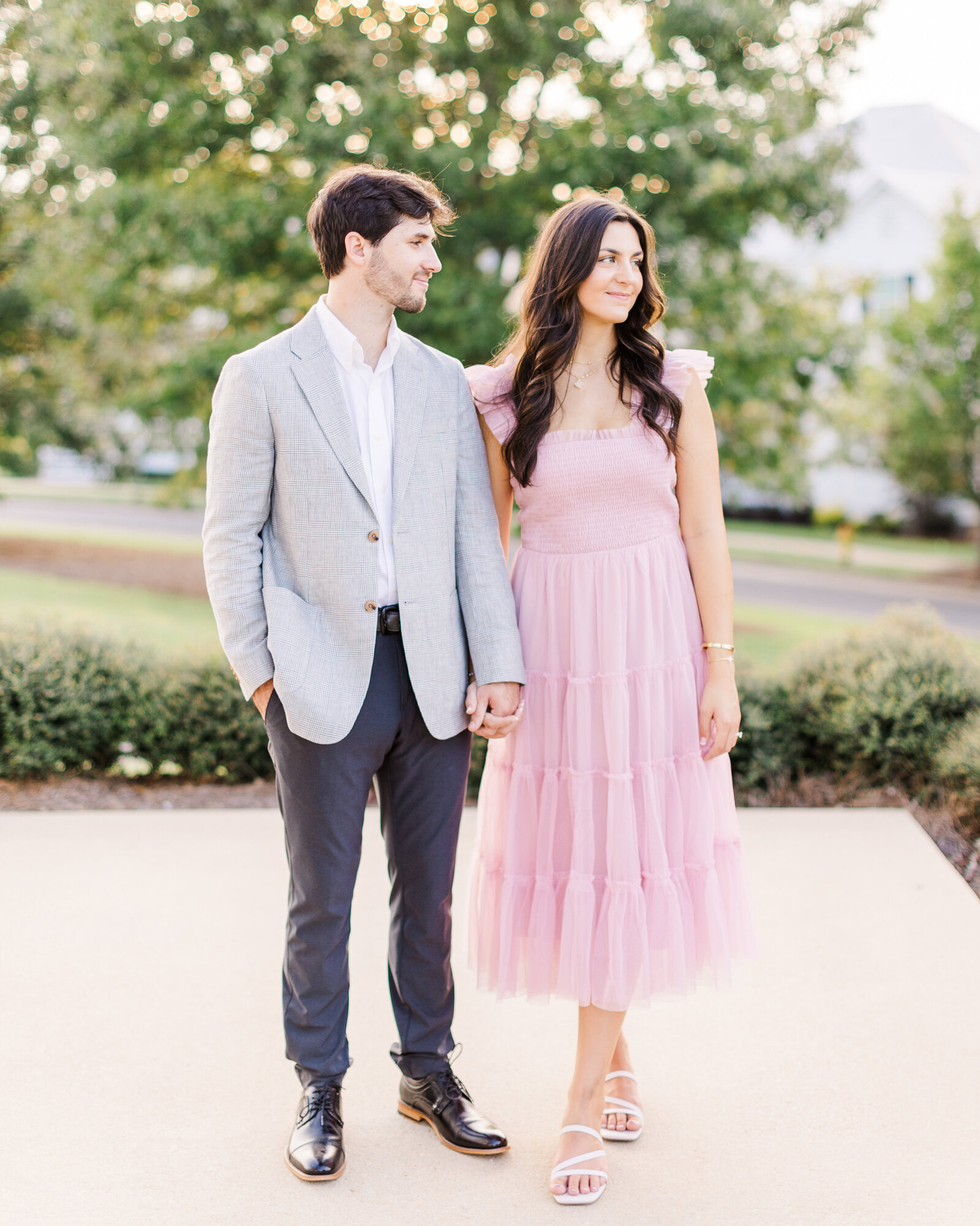 Lauren and Zac standing gracefully outdoors, embracing the natural beauty of Alabama during their engagement session.