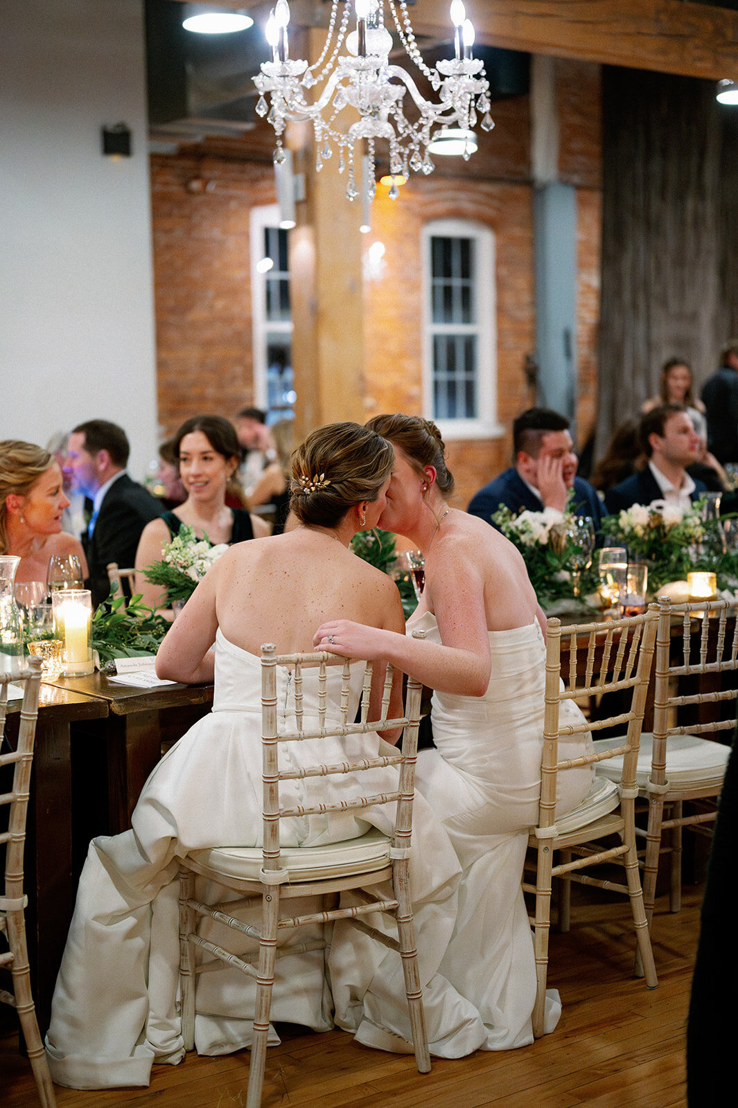 brides-kissing-during-wedding-reception