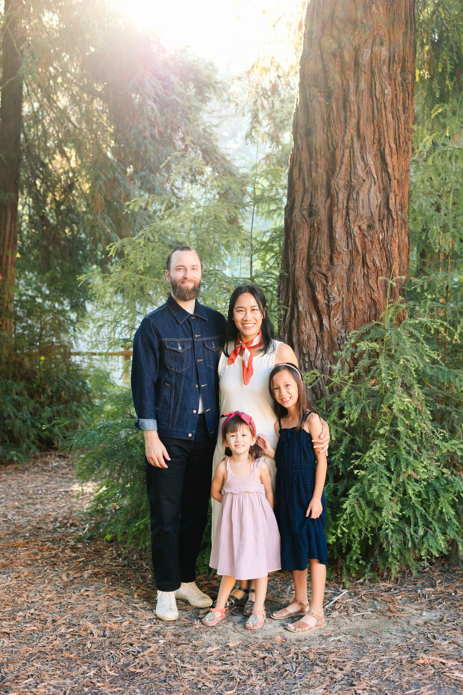 A family poses for photos in a forest in Los Angeles, Ca.