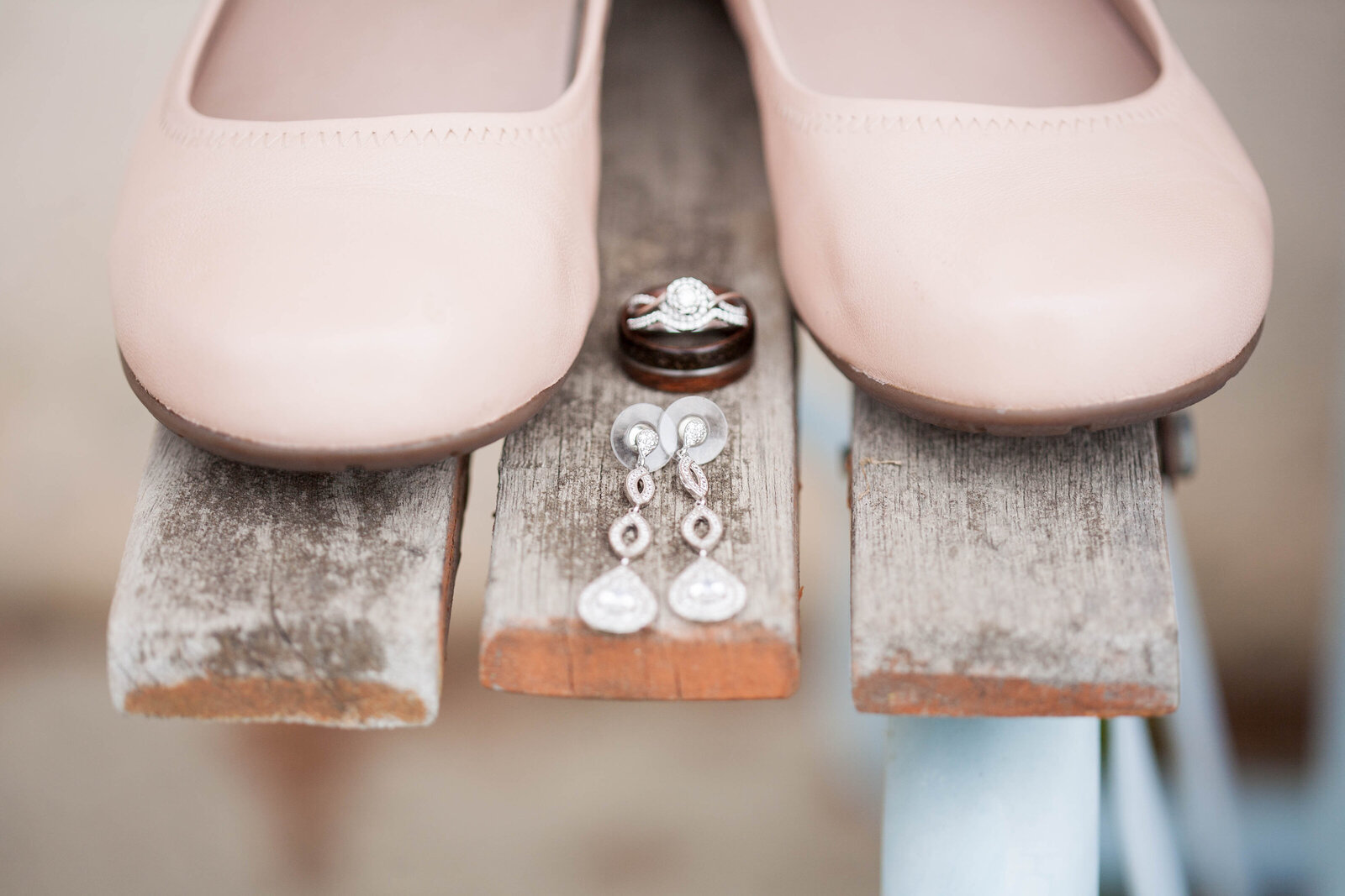 A pair of pink shoes and wedding jewelry.