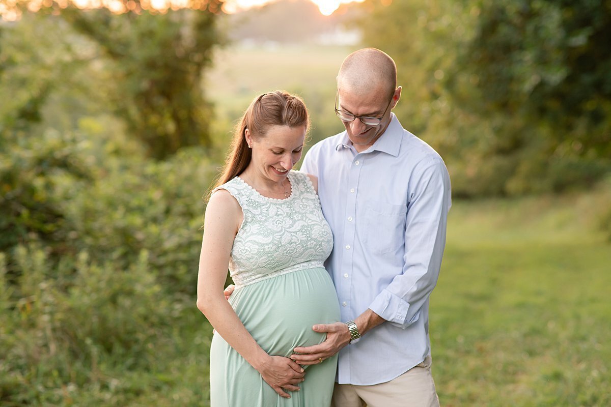 Pregnant couple touching baby belly for Maryland Maternity Photos