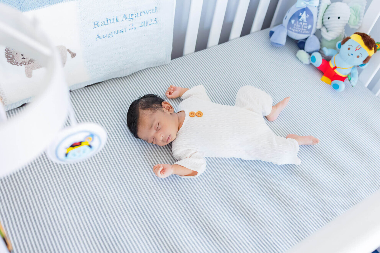 A newborn boy laying in his crib.