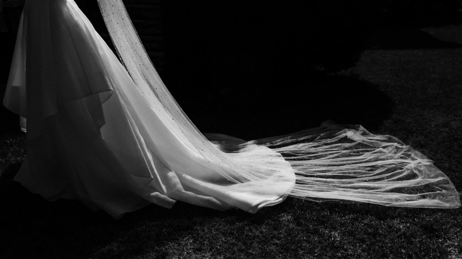 A chiaroscuro detail of amazing light falling on bride's dress