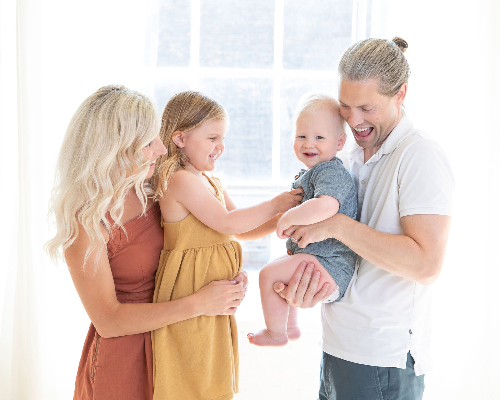 family-laughing-at-baby-boy