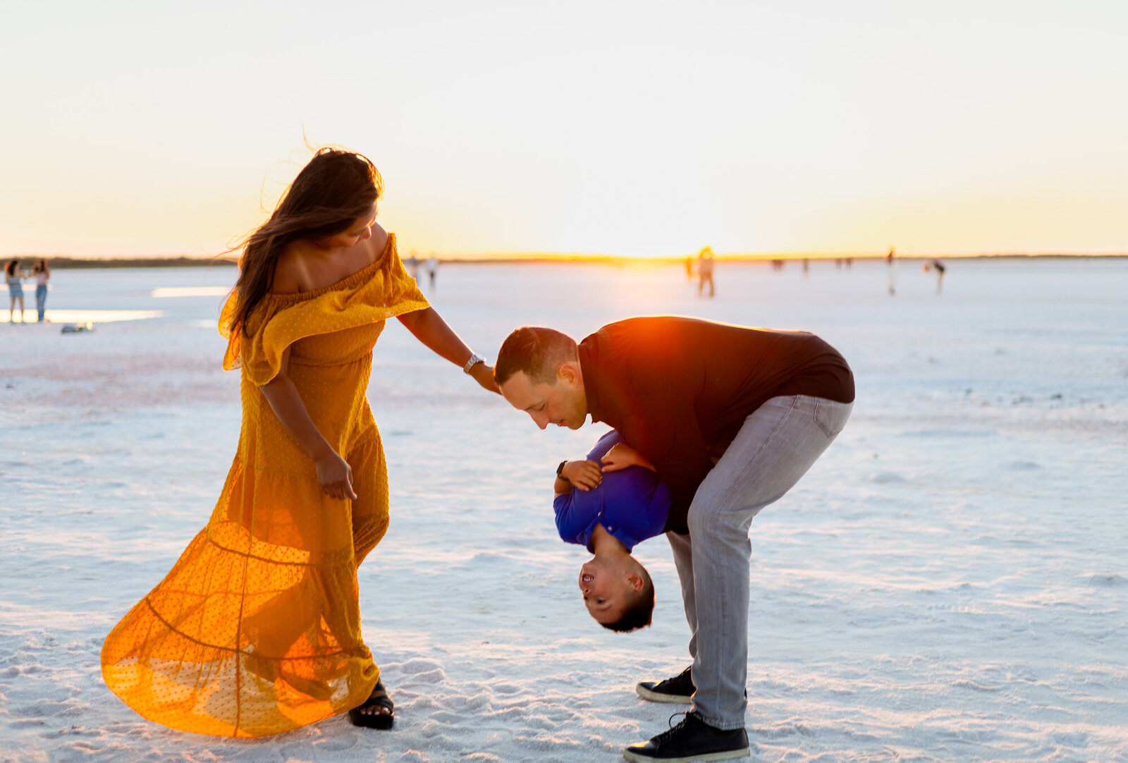 Dad flips son upside down while mom laughs in warm sunset light – Bay Area Family Portfolio - Ellobelle Photography