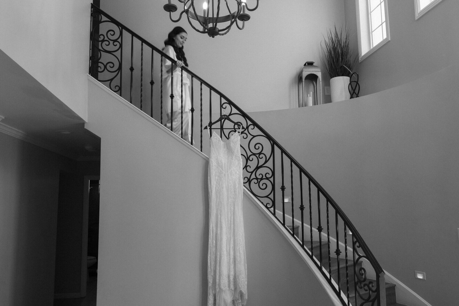 Bride walking down stairs to get into wedding dress taken by Arizona wedding photographer and videographer