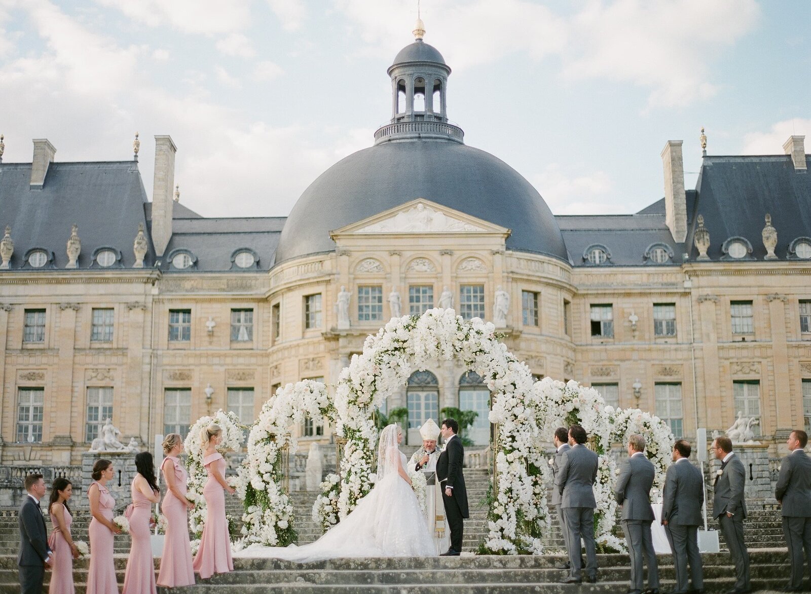 Couple getting married outside chateau in France