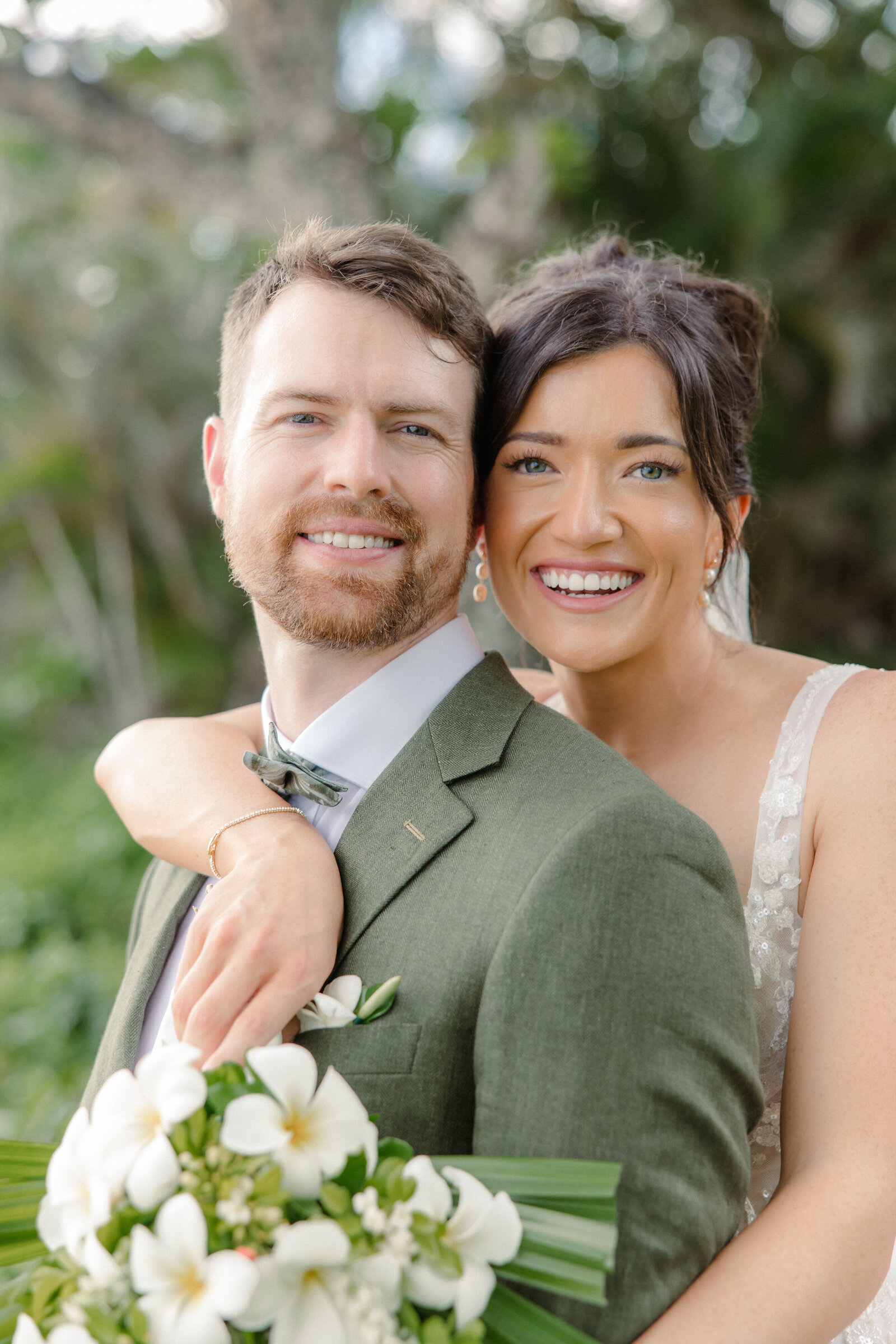 Bride hugging groom from behind