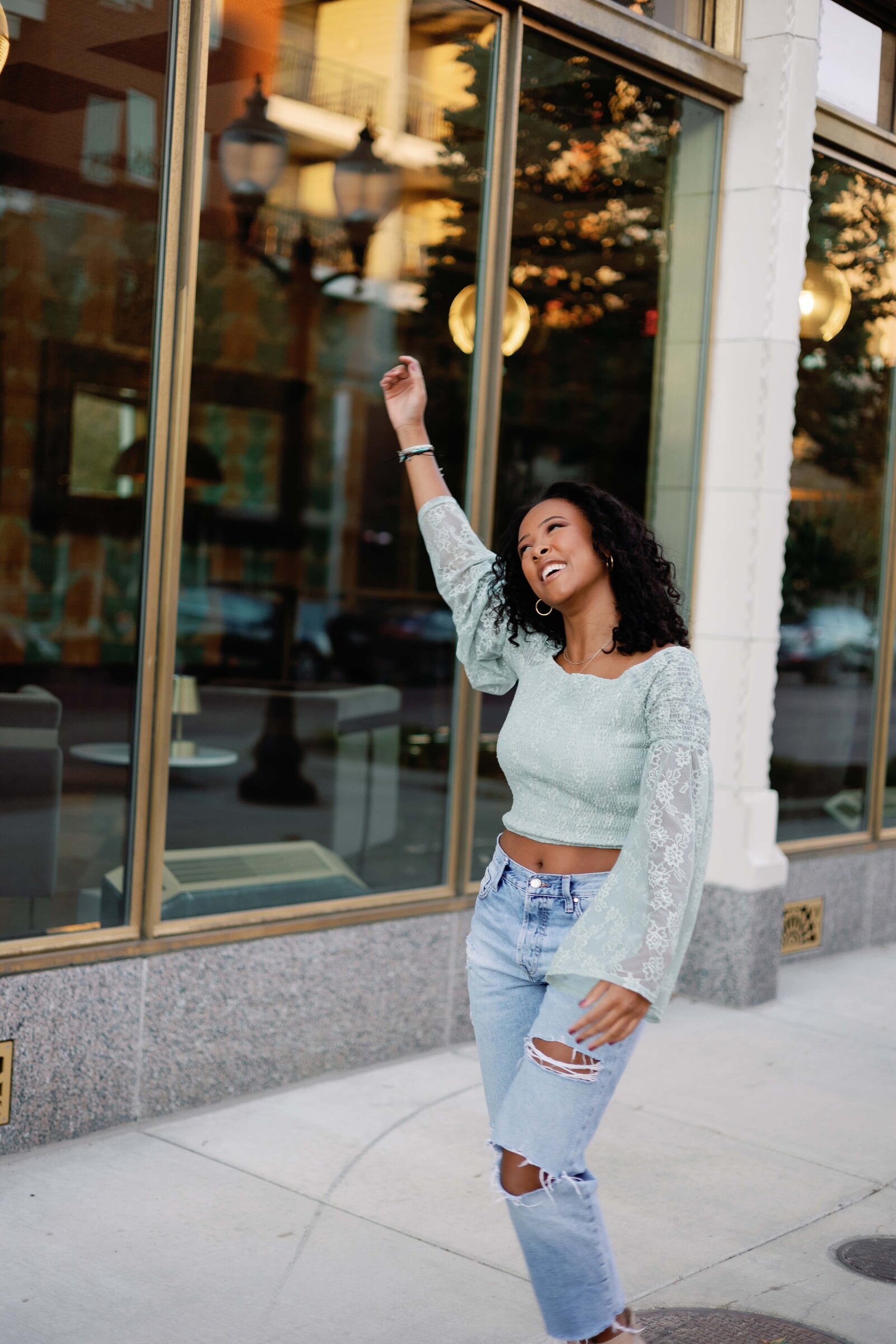 Fun and carefree picture of high school senior female at Bottleworks Hotel in Indianapolis Indiana