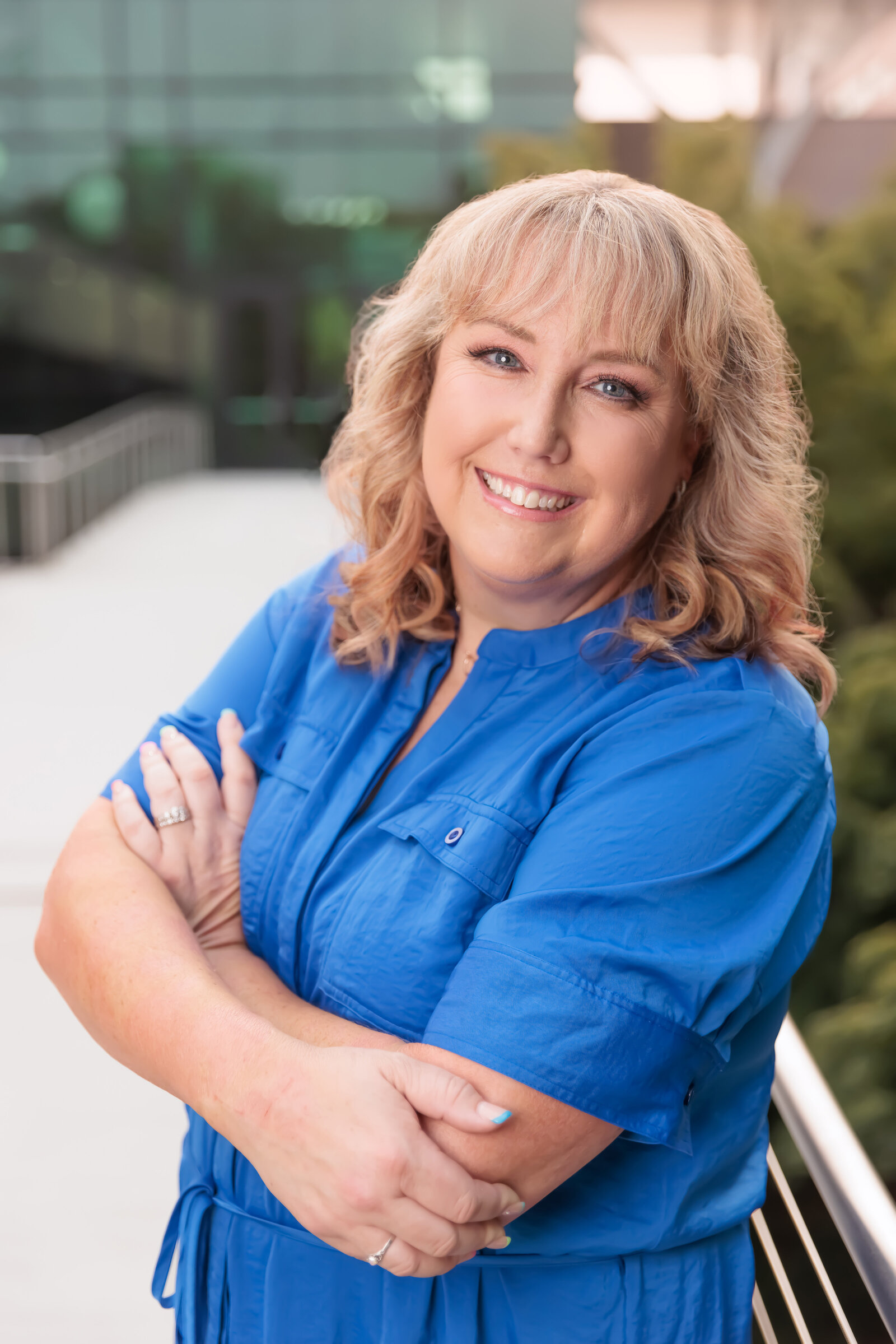 Professional headshots in Cary, NC with a beautiful glass building in the background.