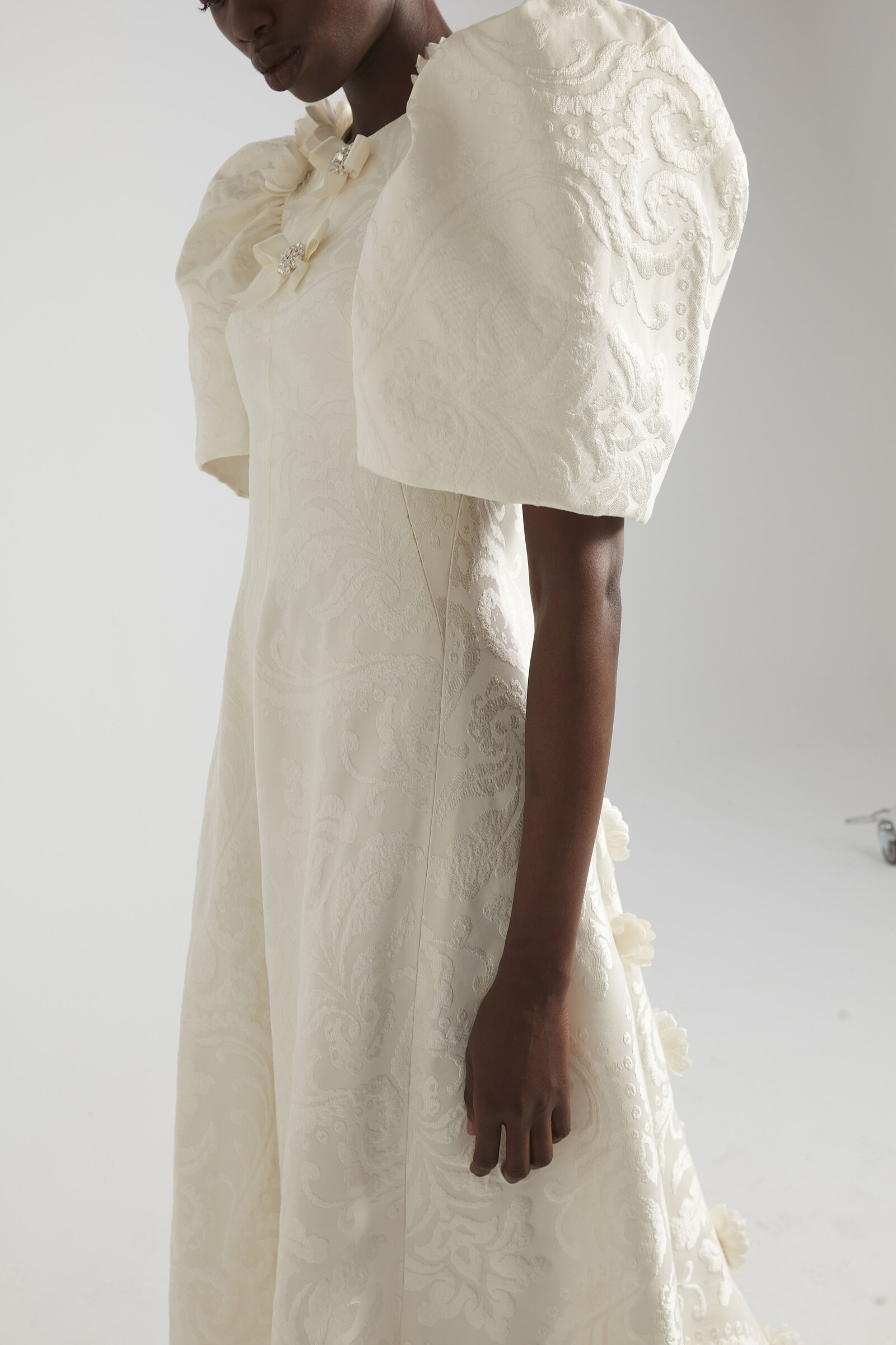 bride wearing textured white wedding dress with puff sleeves