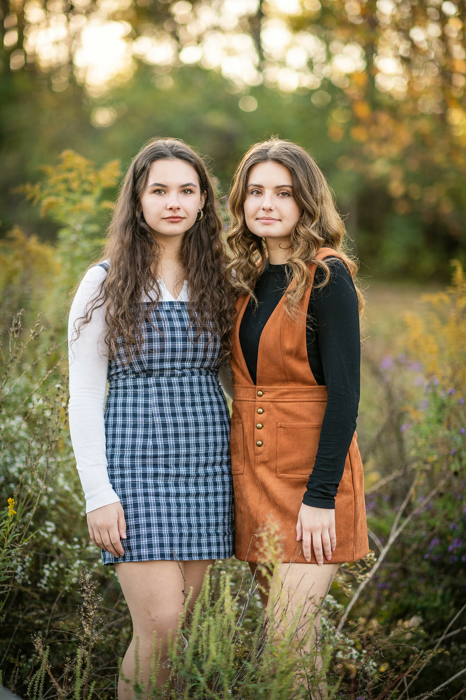 sisters standing in the woods
