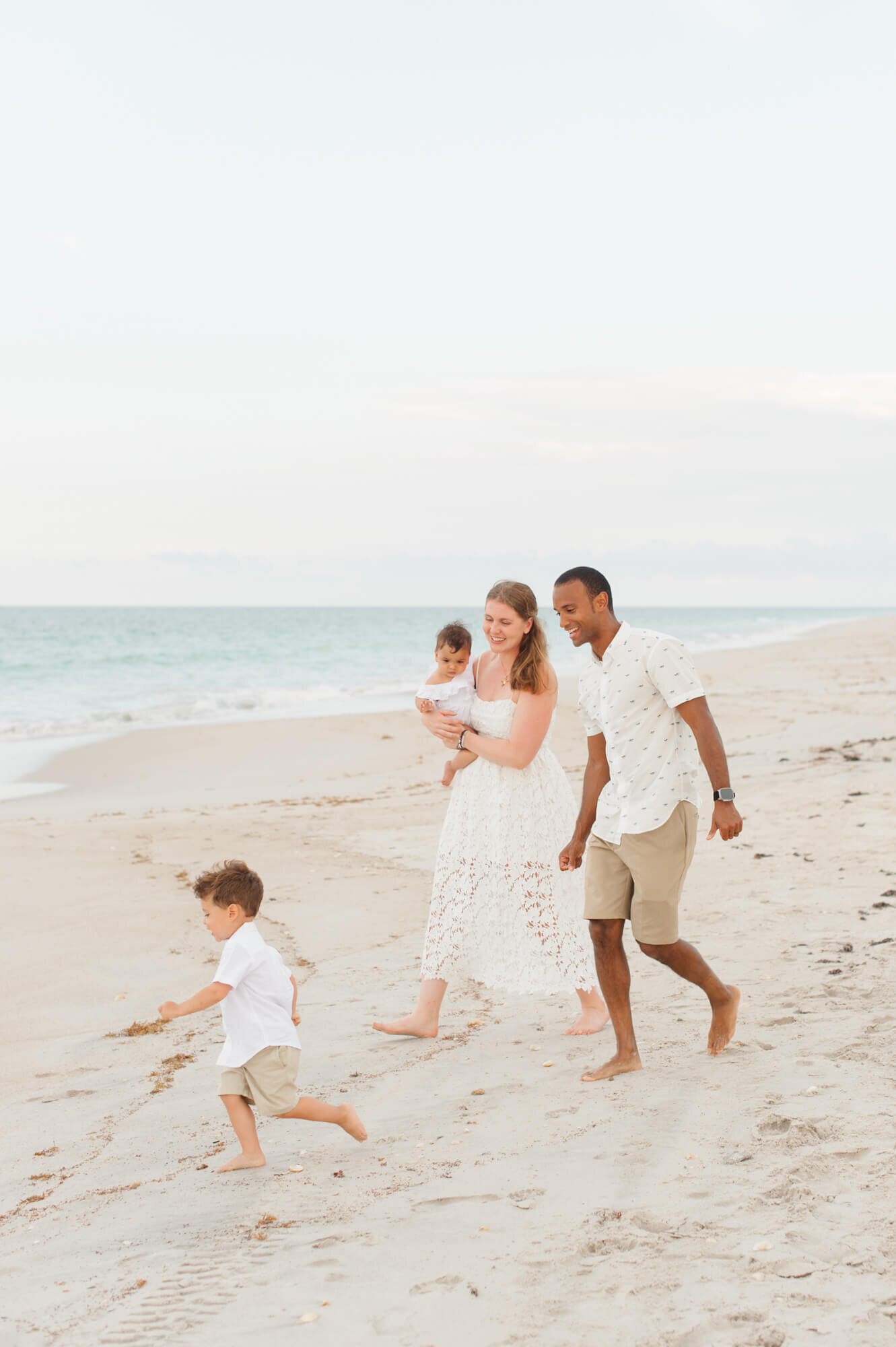 St Augustine family playfully running on beach during their family photos