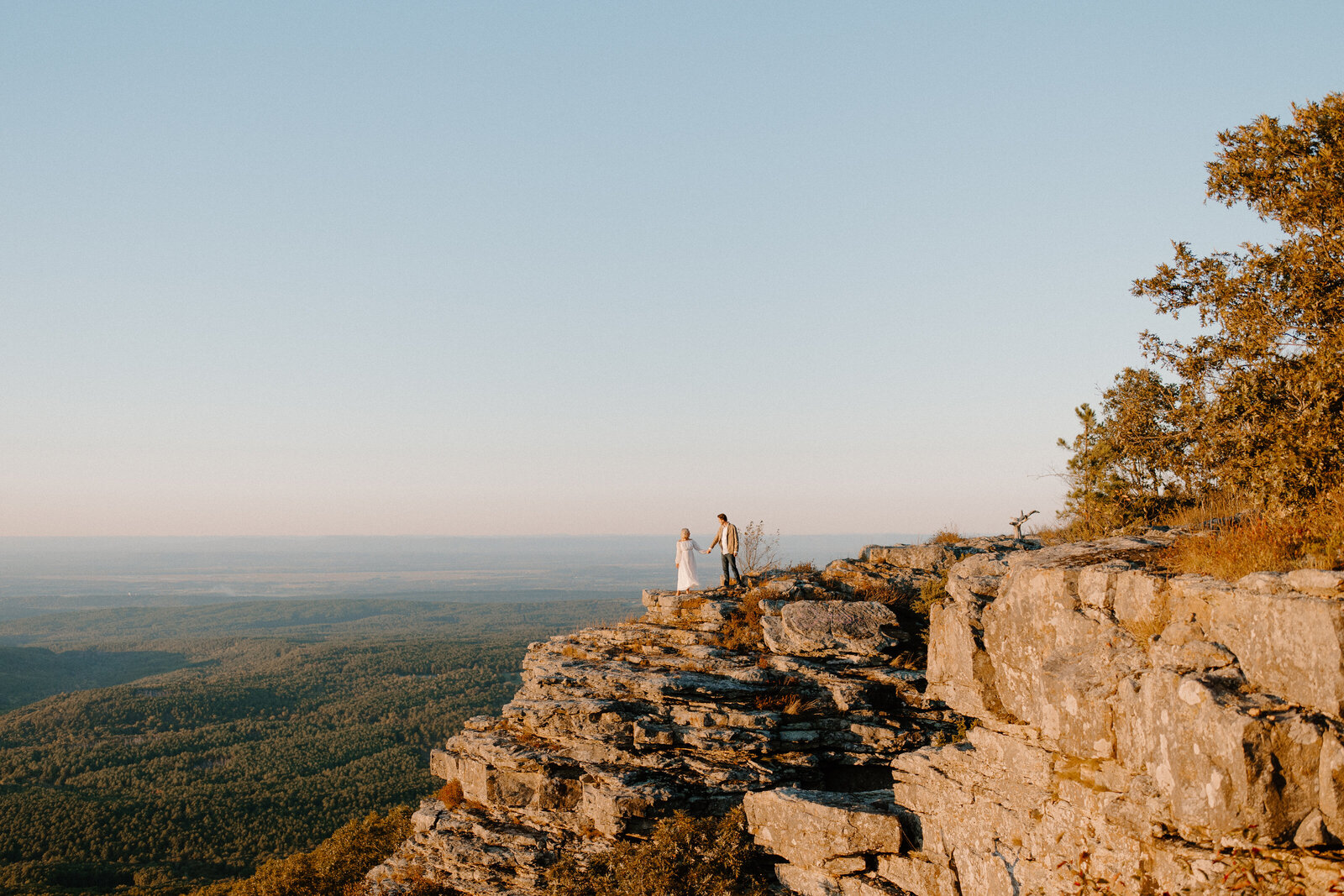 couple holding each other on a mountain top