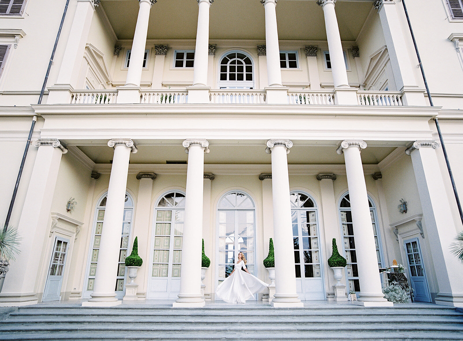 Bride twirling on the steps of villa. Photographed by Italy wedding photographer Amy Mulder Photography