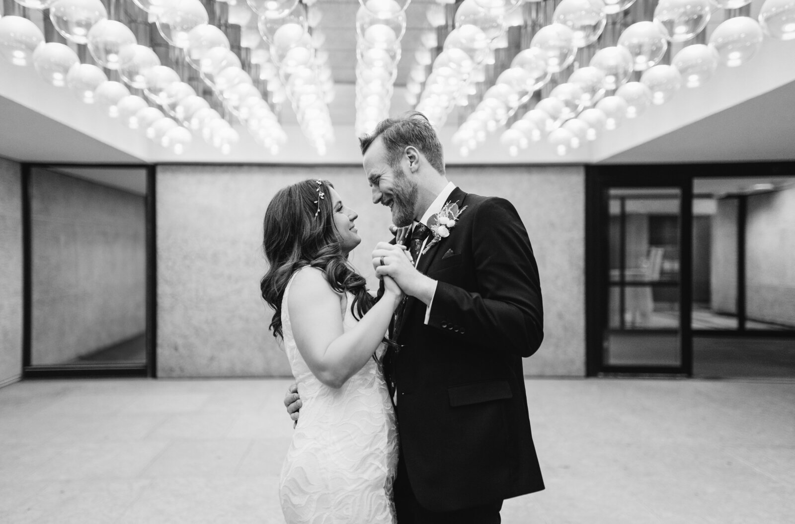 A bride and groom dance outside of the Winnipeg Art Gallery.