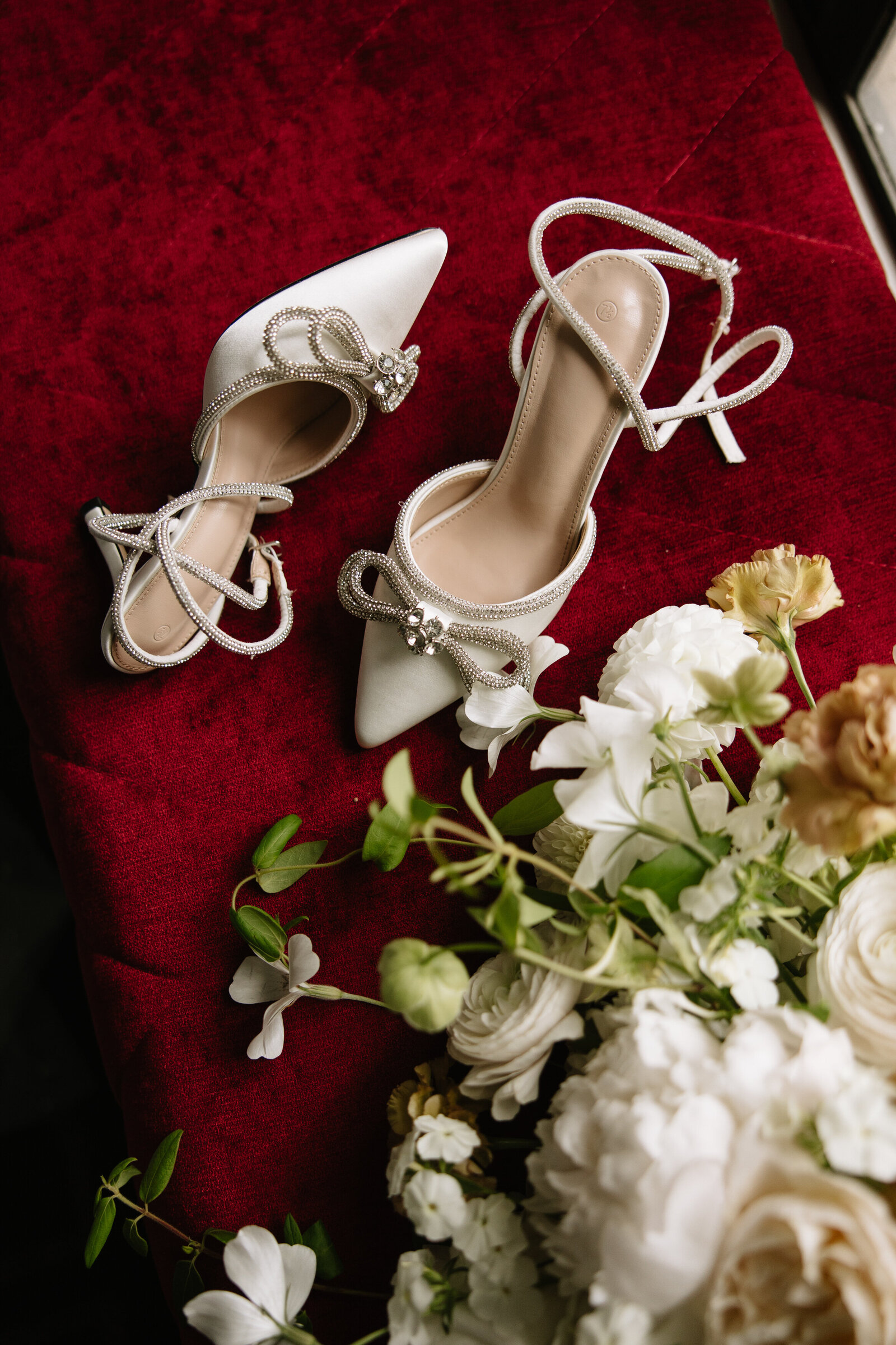 Details of bride's bouquet and shoes before San Francisco City Hall elopement